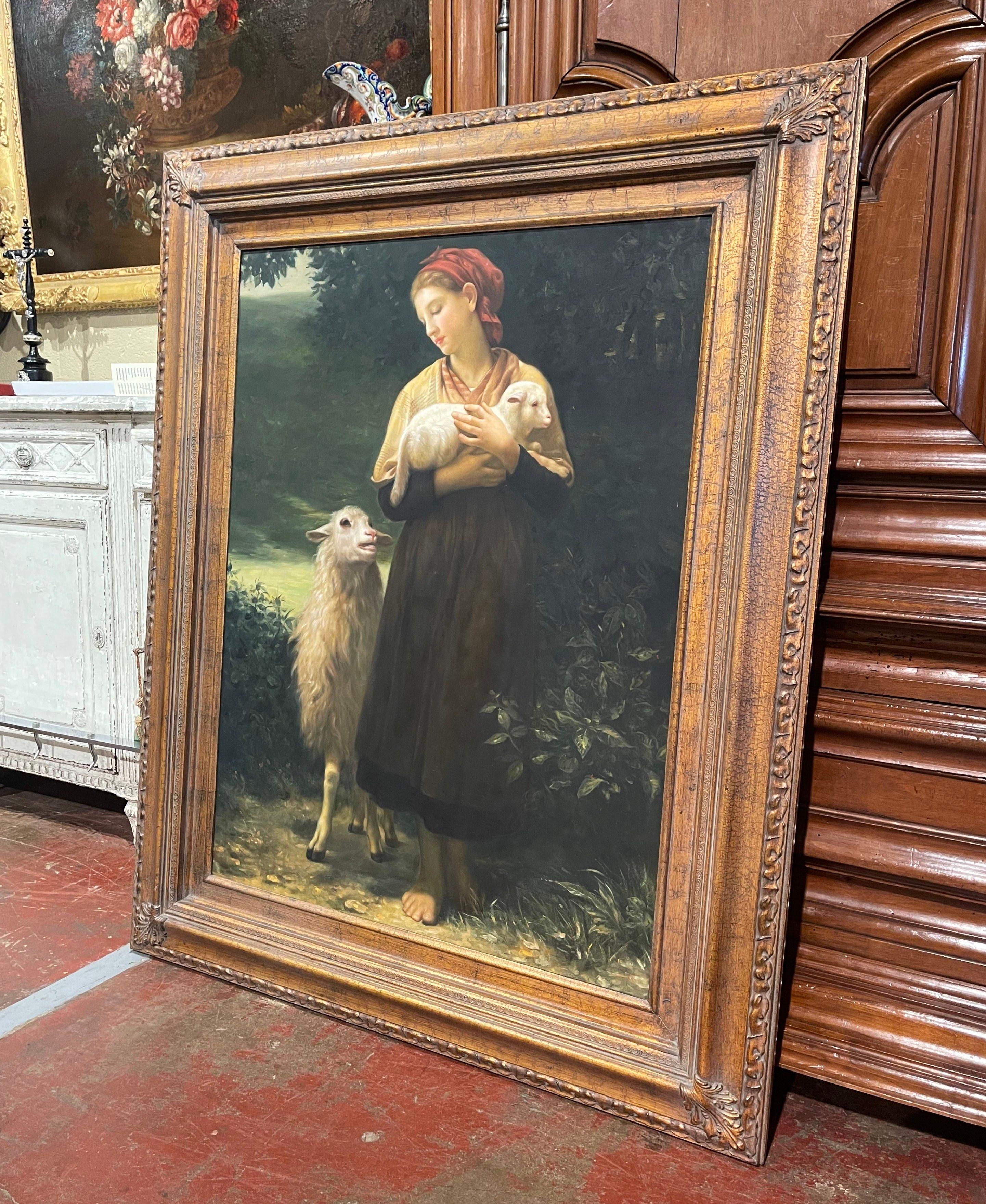 Decorate a wall with this large vintage painting. Crafted in France circa 1970 and set in the original carved gilt frame, the artwork depicts a peasant woman holding a newborn lamb, with a sheep, probably the mother, looking at the baby. The sweet