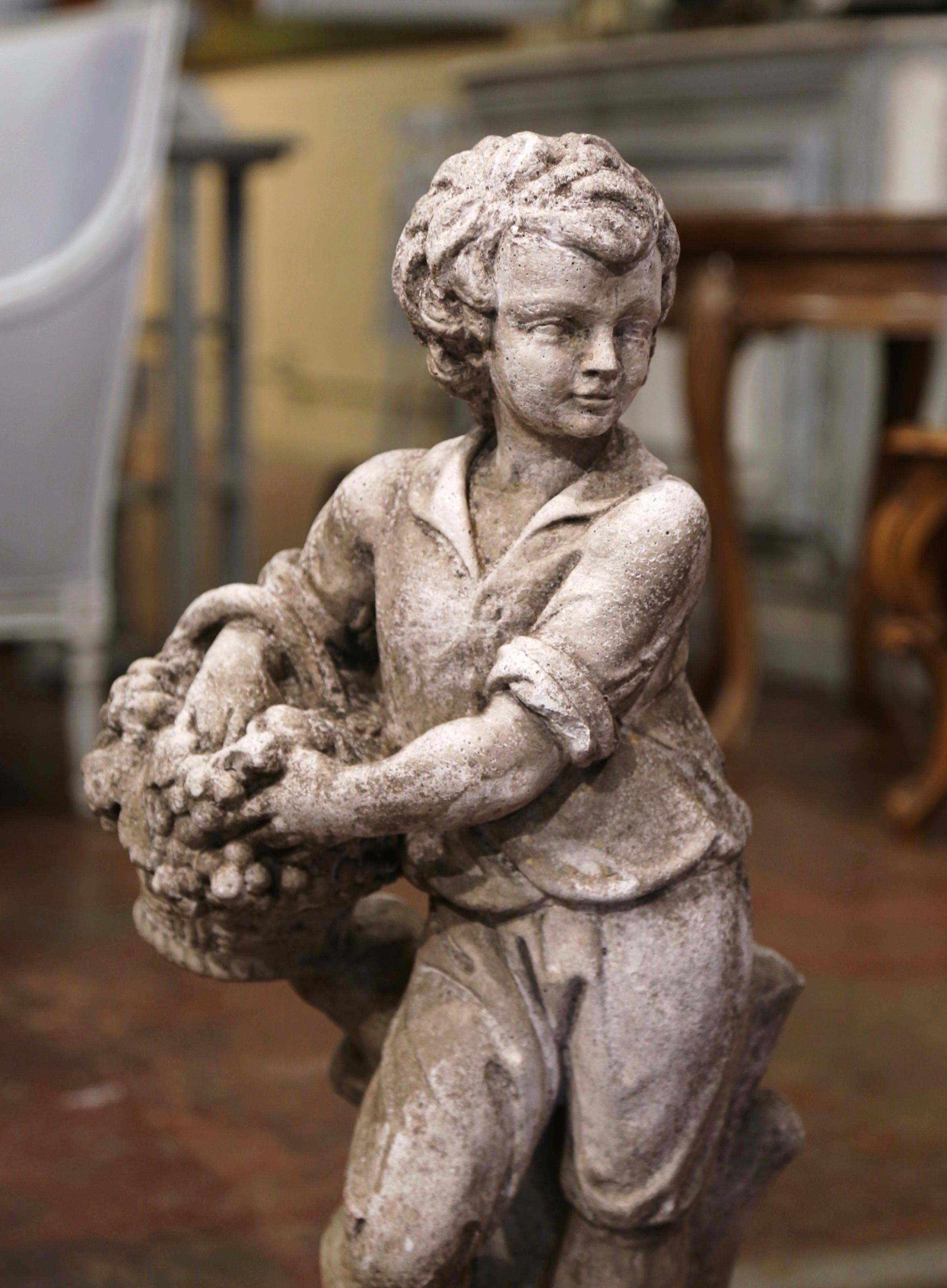 Decorate a garden or patio with this elegant antique outdoor statue. Hand carved of stone in France circa 1960, the figure is an allegorical representation of Autumn or fall, and depicts a standing young boy leaning against a tree stump and holding