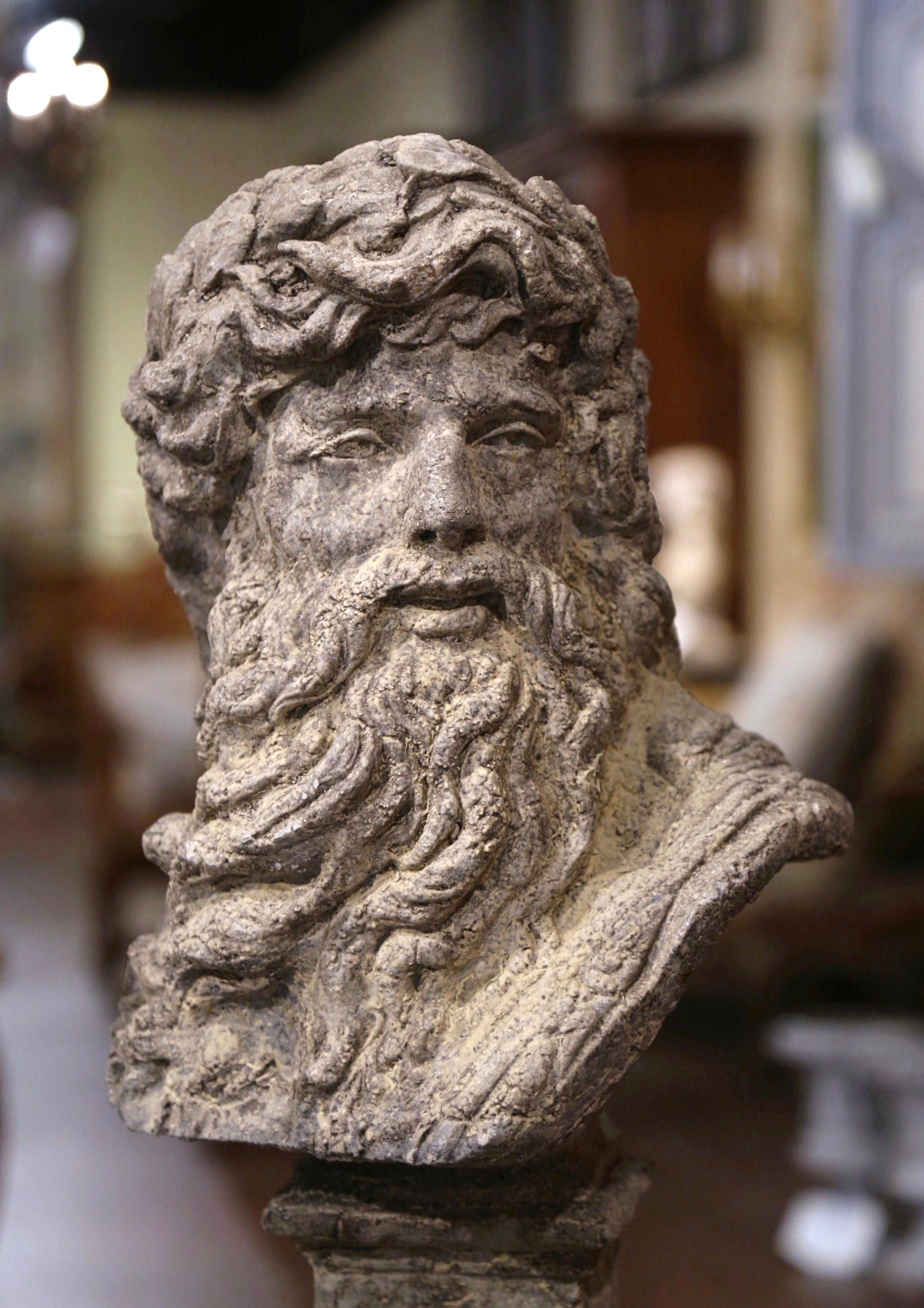 Decorate a garden or patio with this elegant antique outdoor statue of Zeus. Carved of stone in France circa 1950, the large figure stand on integral pedestal base, and depicts the Greek god Zeus, bearded head turned to the side. The tall statuary