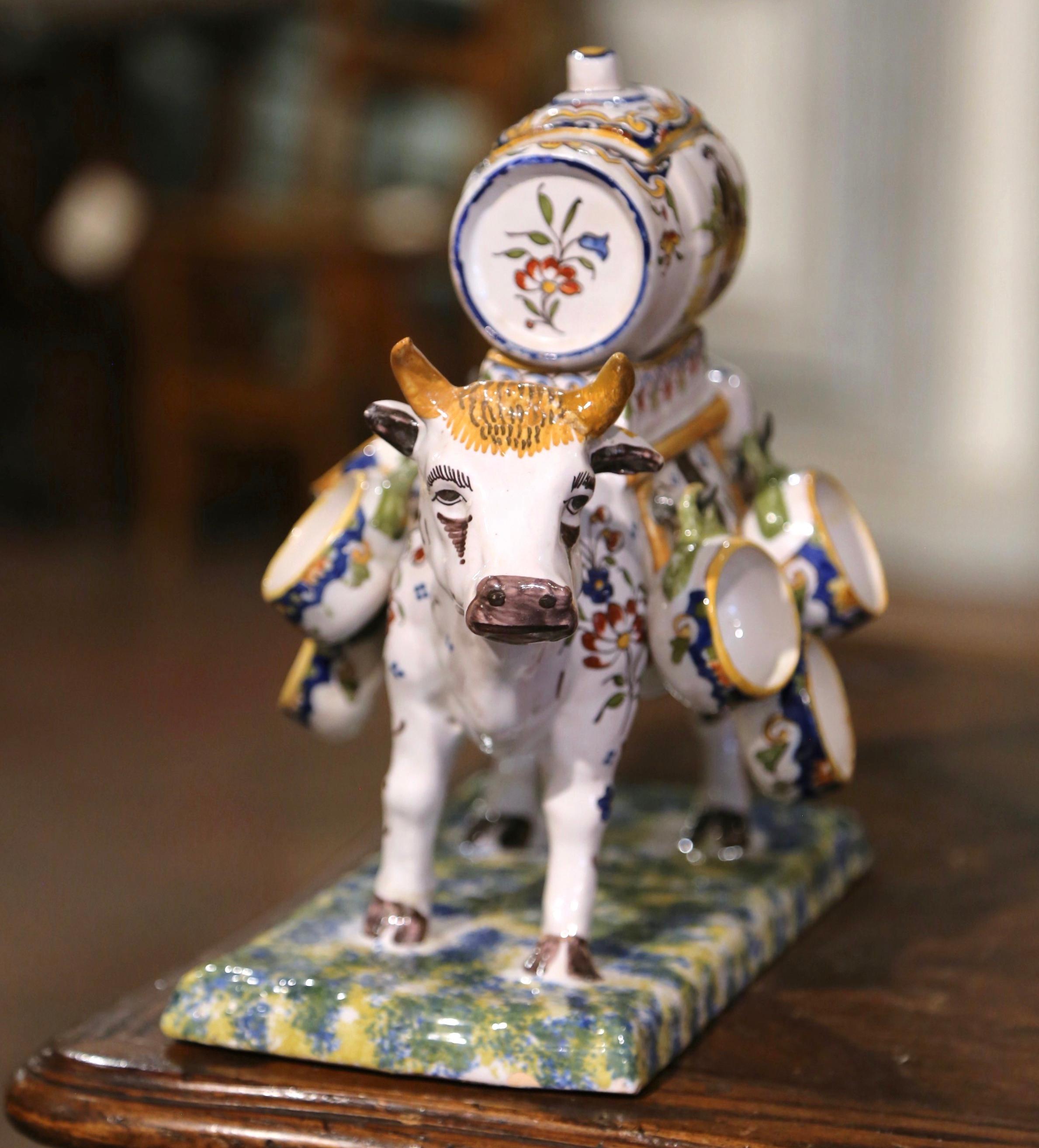 Decorate a bar with this colorful, antique Majolica sculpture composition! Created in Normandy, France circa 1960, the ceramic jardinière features a cow sculpture carrying a Calvados barrel with its original metal faucet and its removable top; it is