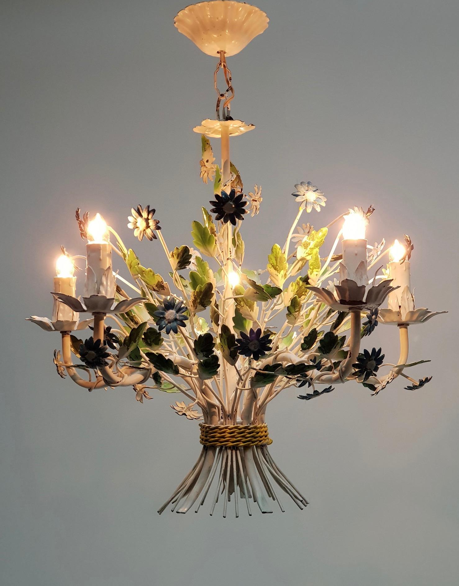 This elegant, midcentury chandelier was crafted in France, circa 1960. The charming hanging light fixture has five lights and is embellished with realistic blue flowers and green leaves. The round chandelier is in good vintage condition and has its
