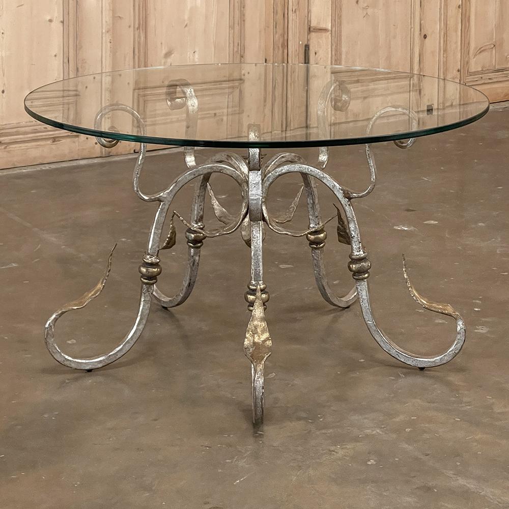 Midcentury French painted wrought iron and glass round coffee table is the perfect choice for protected outdoor entertaining or interior casual decors that need a little panache! The thick glass top will provide carefree daily use, and features a
