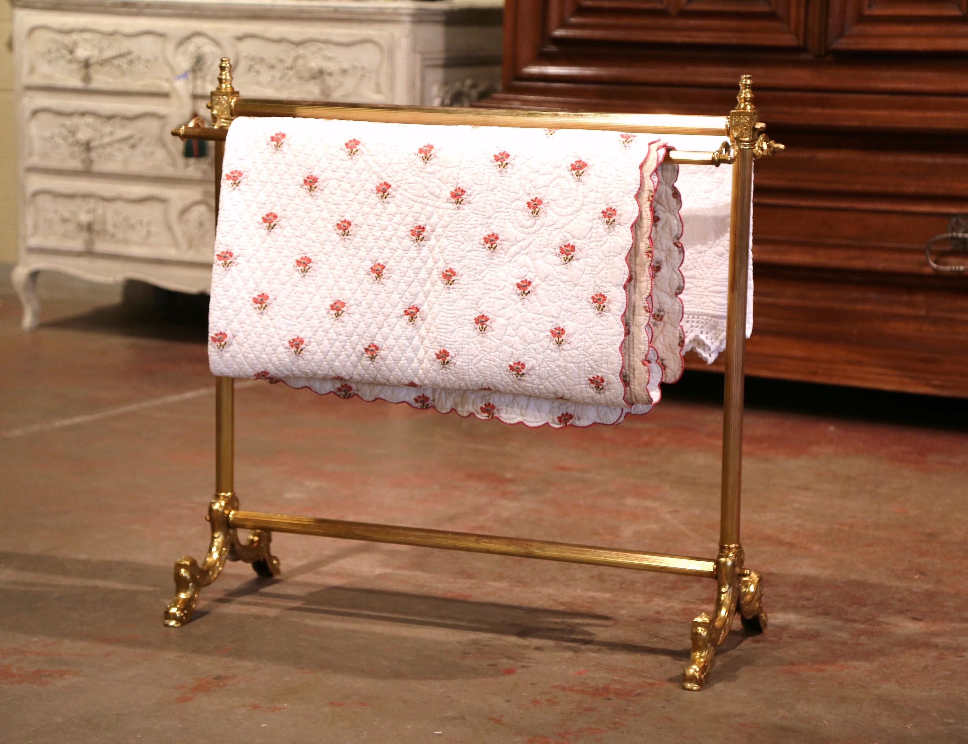Display your antique quilt collection on this vintage free standing rack, crafted in France circa 1960 and made of brass, the rack stands on a double pedestal base and features three rails to hang blanket or other fabric. The display essential is in