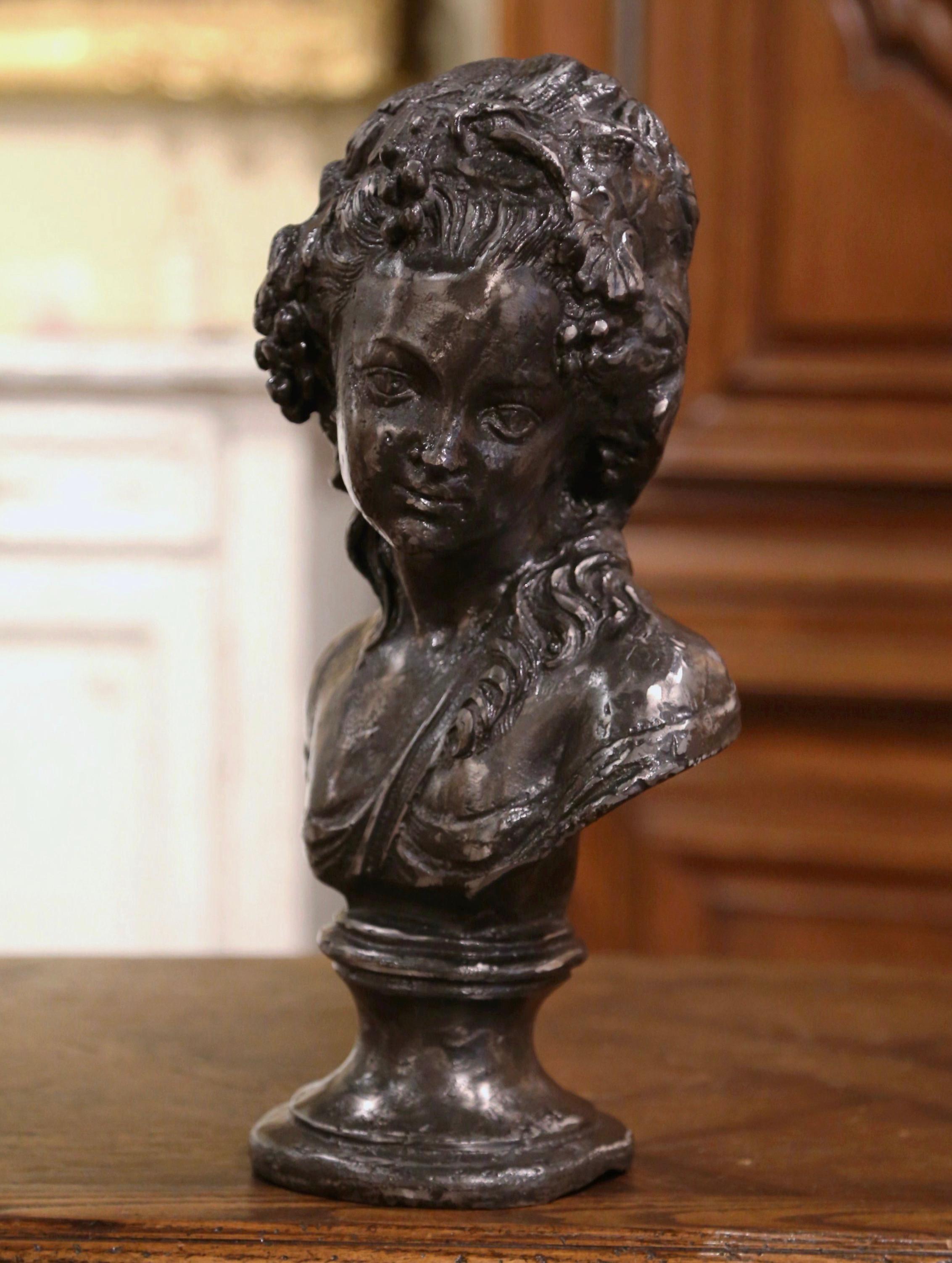 Decorate a shell or wine cellar with this elegant bust. Hand crafted in France circa 1970, and built of iron, the bust sits on an attached round base, and depicts a young female 