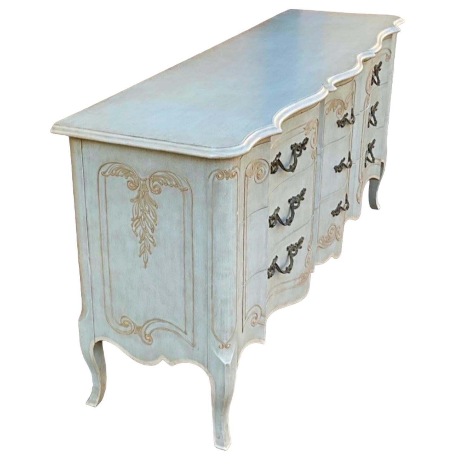 This is a French Provincial chest in an original French blue paint by John Widdicomb. It has the original brass hardware and dovetail construction. The nightstands are available as well.