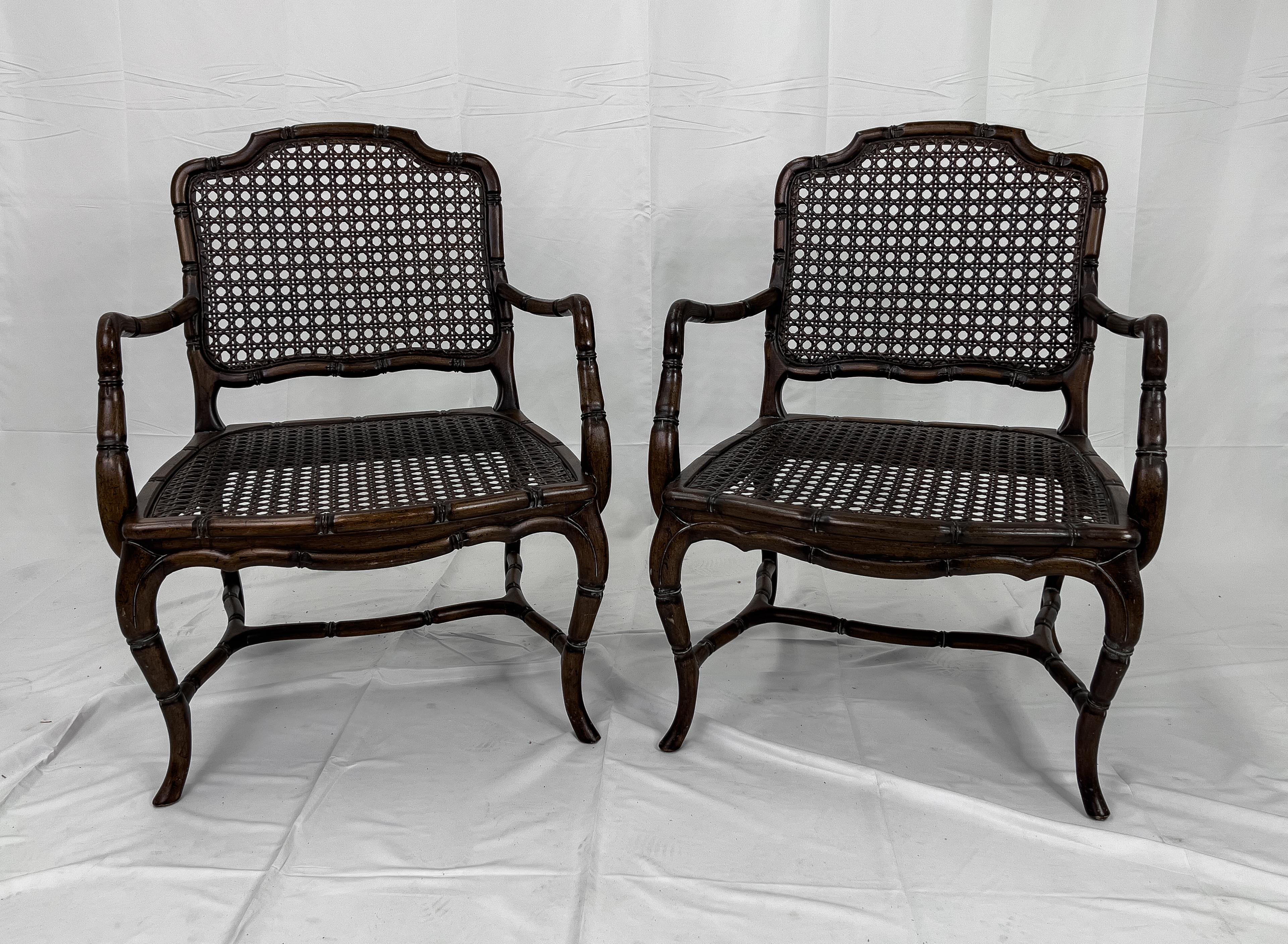 Mid Century French Provincial Country Cane Faux Bamboo Wood armchairs - a Pair. Faux bamboo framed armchair with cabriole legs, cross and side stretchers and a caned back and seat.