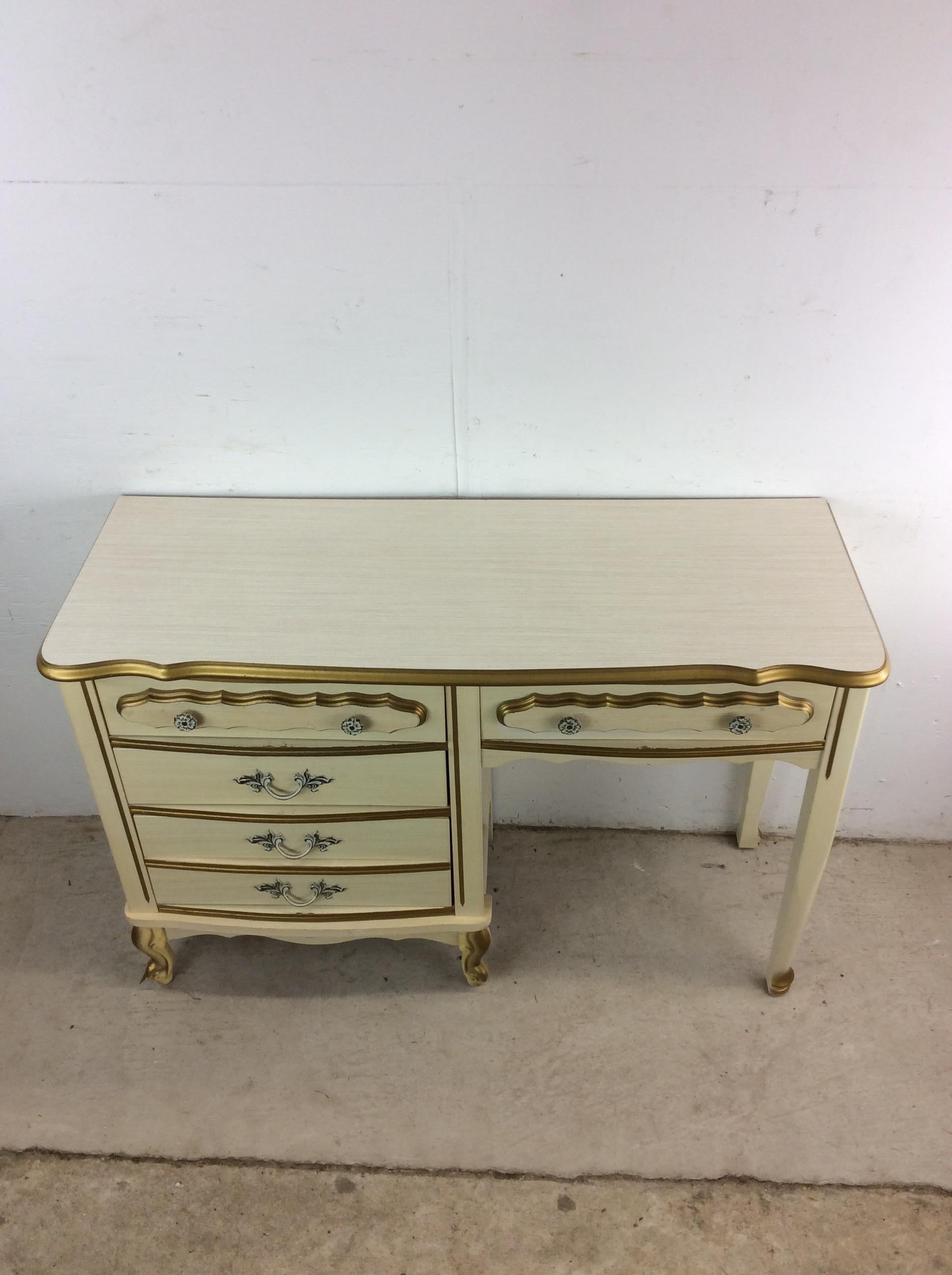 This mid century French provincial style writing desk features pressed wood construction, white lacquer finish, four dovetailed drawers with ornate hardware, and tapered legs.   Matching Highboy, lowboy, and pair of end tables.

Dimensions: 44.25w