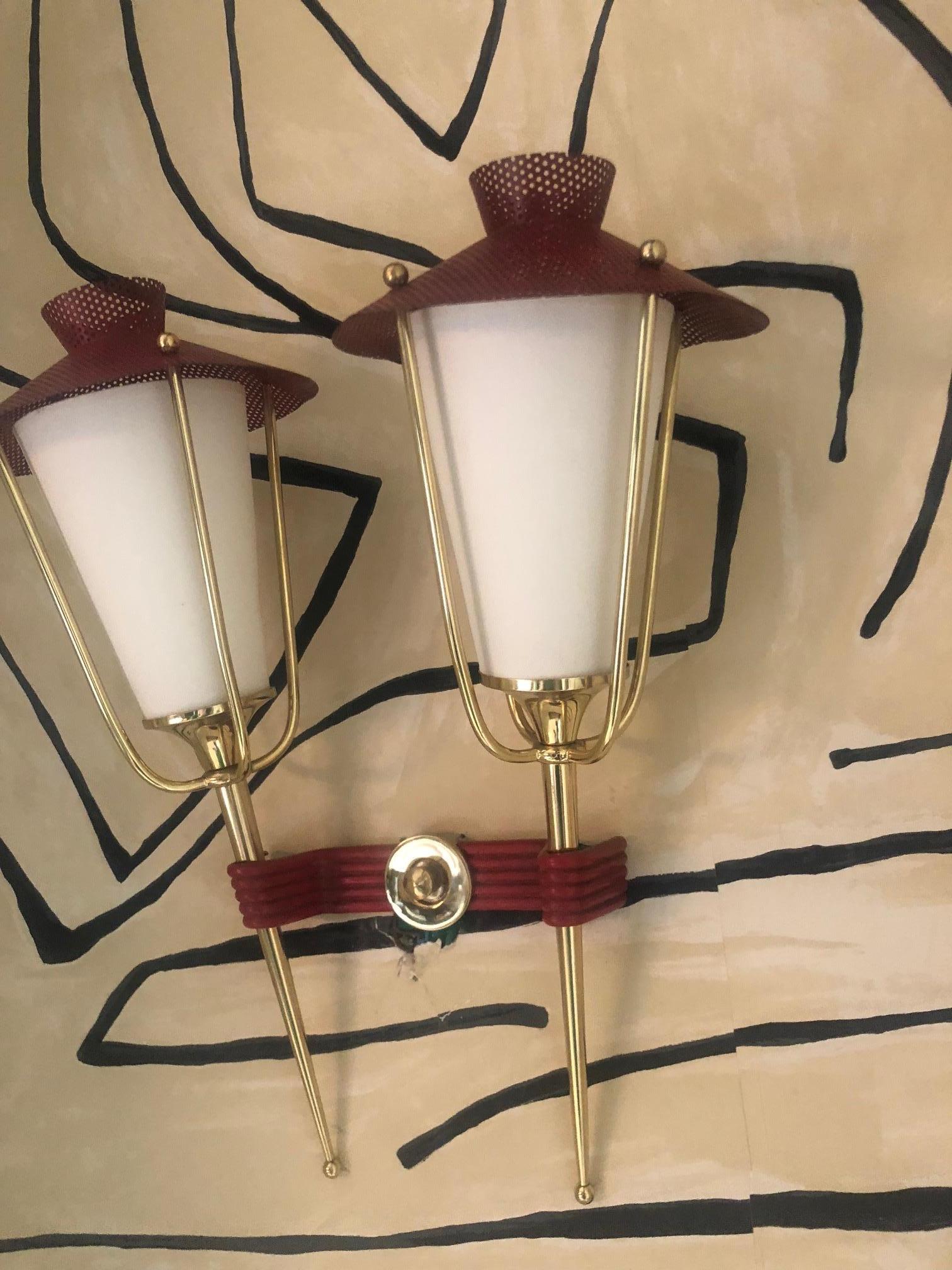 Midcentury pair of French red and brass wall sconces by Maison Arlus. Lantern shaped double wall lights with brass and red powder-coated metal hats. The paper shades emit a beautiful diffused light. Brass has been refinished.