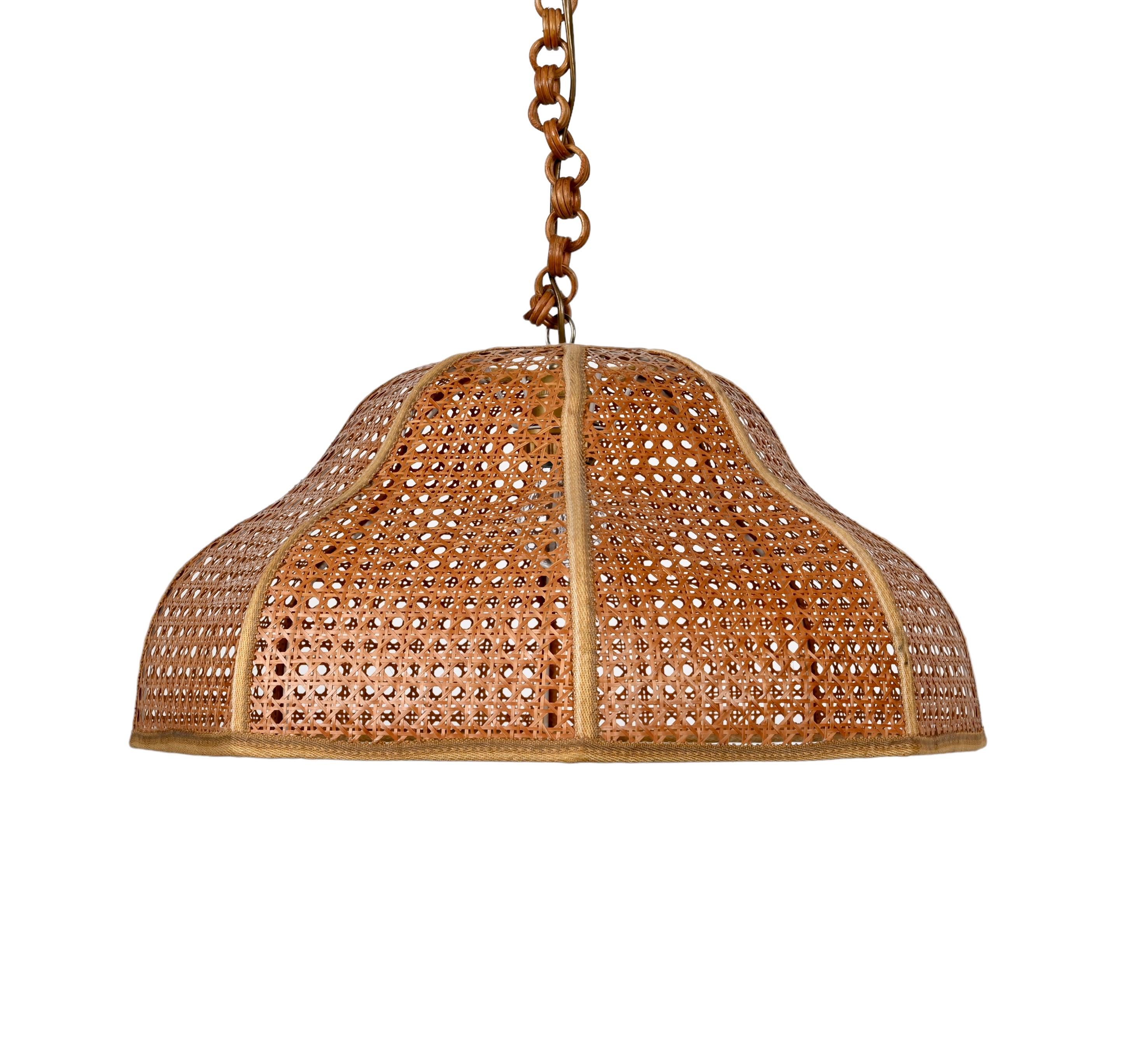 Remarkable mid century rattan and wicker pendant chandelier in the French Riviera style. This incredible piece was made in Italy during the 1960s.

This item is surprising because of the curved bamboo lampshade and a wicker cover structure. A