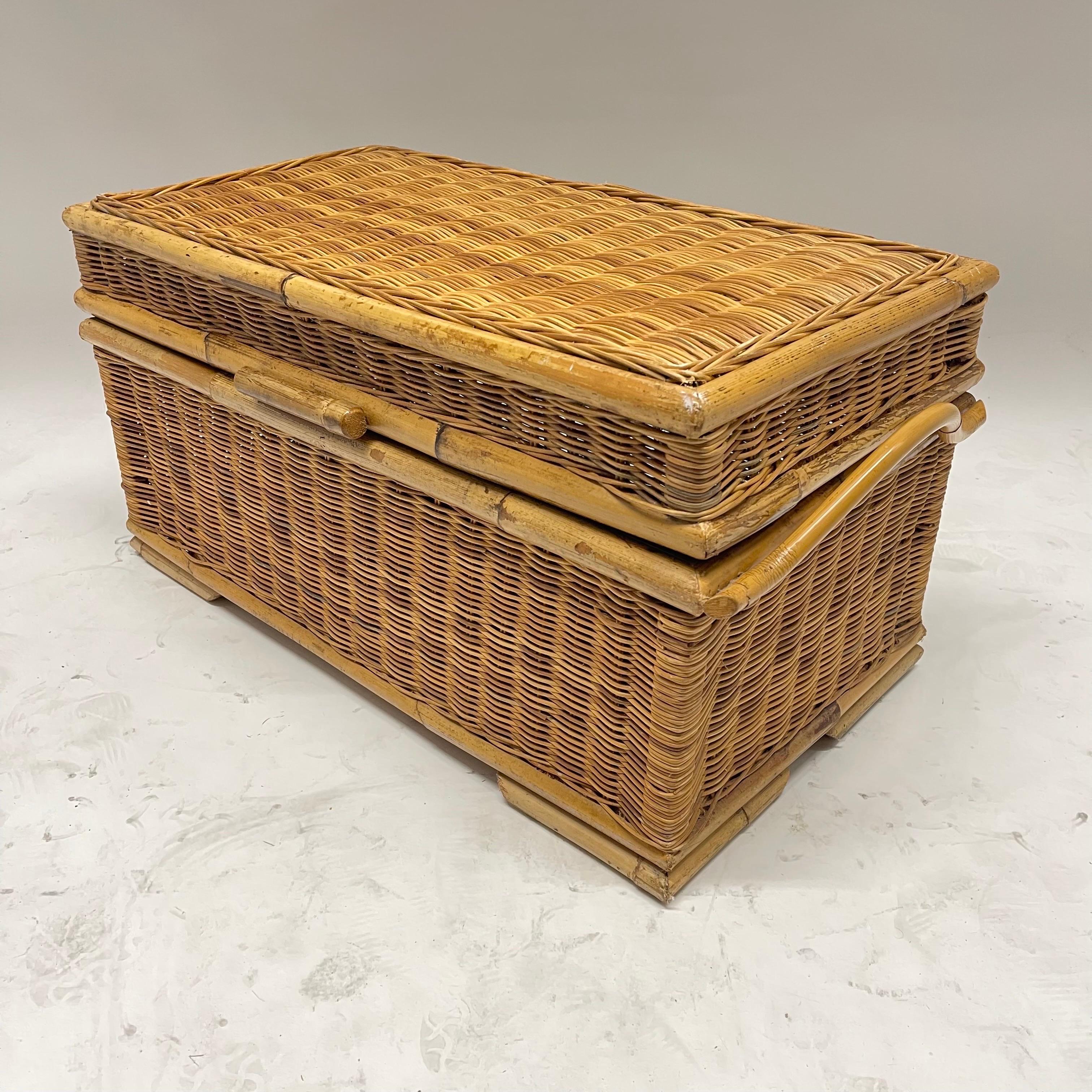 Mid century French Riviera trunk, blanket chest, toy chest, or large picnic basket. Rendered in hand woven wicker with bamboo bent rattan handles, feet, and frame. Made in France, circa 1970s.