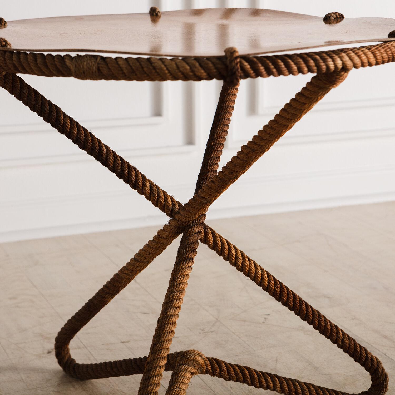 A mid century French Rope side table with a tripod shaped base and a resin top with a fibrous crosshatch pattern.