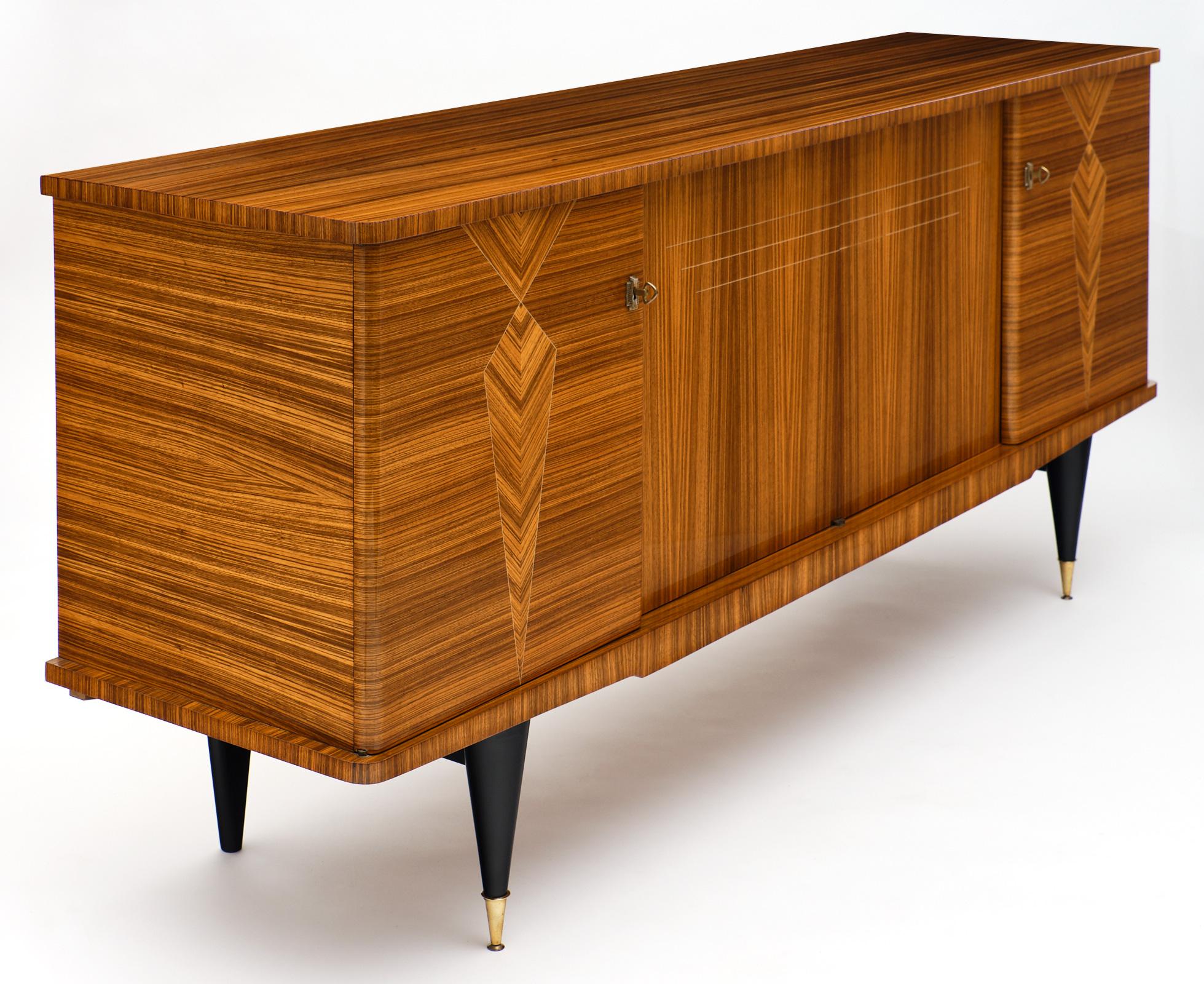 French midcentury rosewood buffet with superb rosewood veneer marquetry and parquetry. This piece displays very high levels of craftsmanship. The four doors open to reveal ample storage space and a lemon wood interior. There are shelves and two
