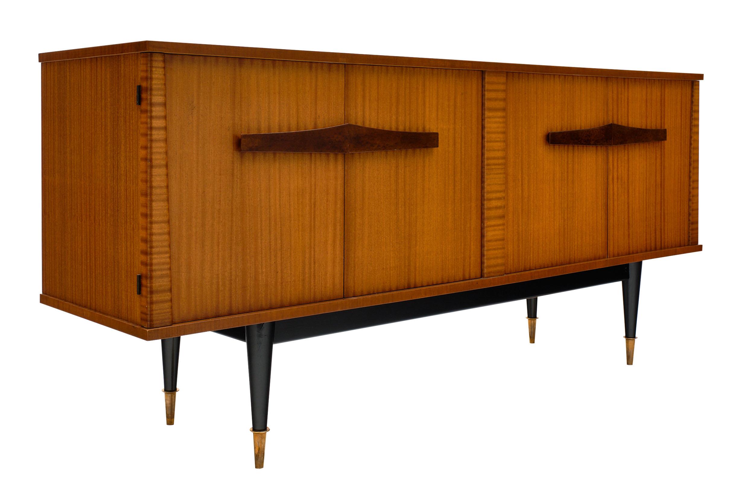 Midcentury French rosewood buffet with a banded rosewood and tinted rosewood handles. The tapered legs and capped with gilt brass feet. We love the elegance of this modernist piece. The doors open to reveal interior shelving and drawers.
