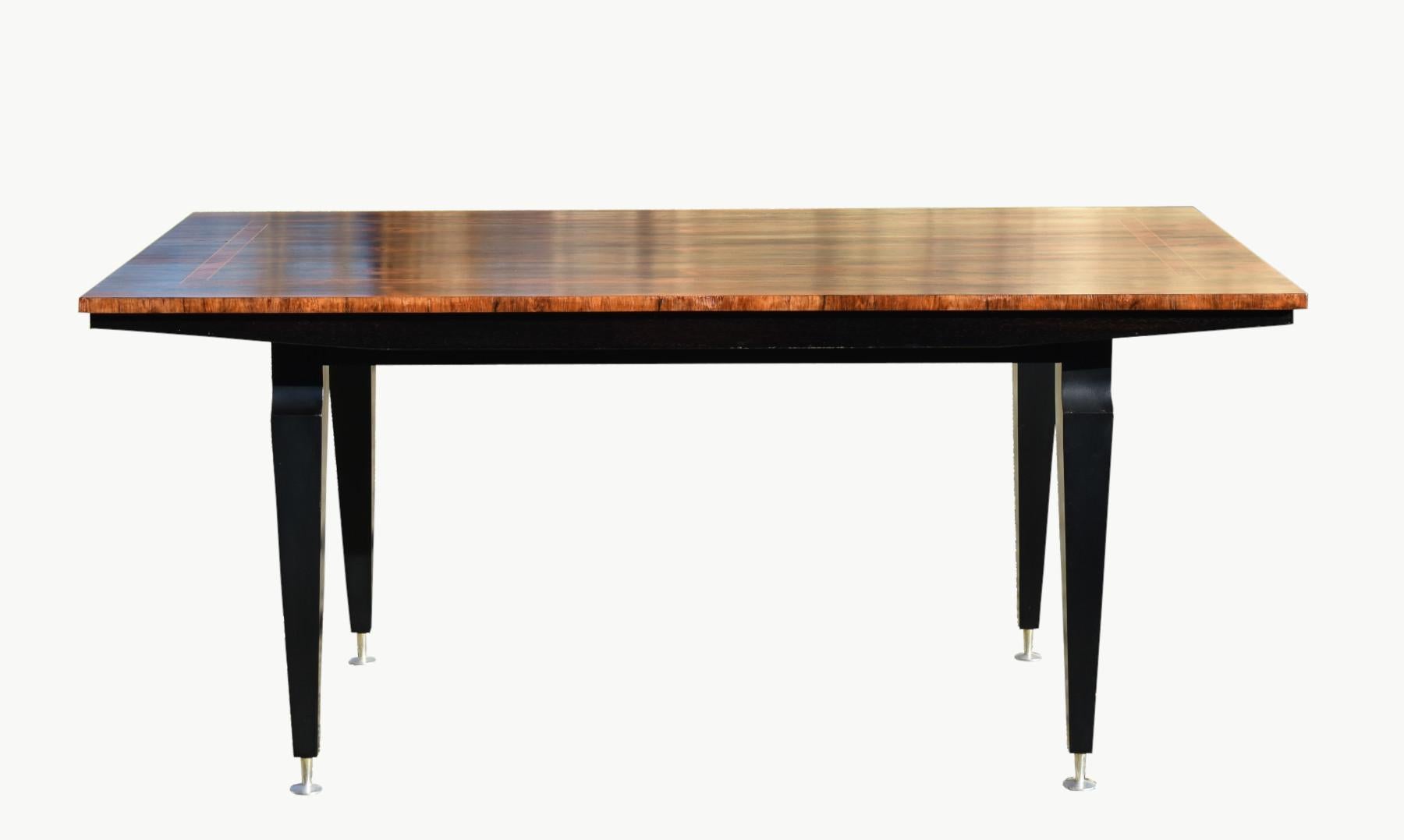 Mid-Century French Rosewood Dining Table

A stylised inlaid Rosewood Dining Table with a well-figured book-matched top in rosewood.

The frieze below is ebonised with a piano glass finish.

The table features tapered legs leading down to fine