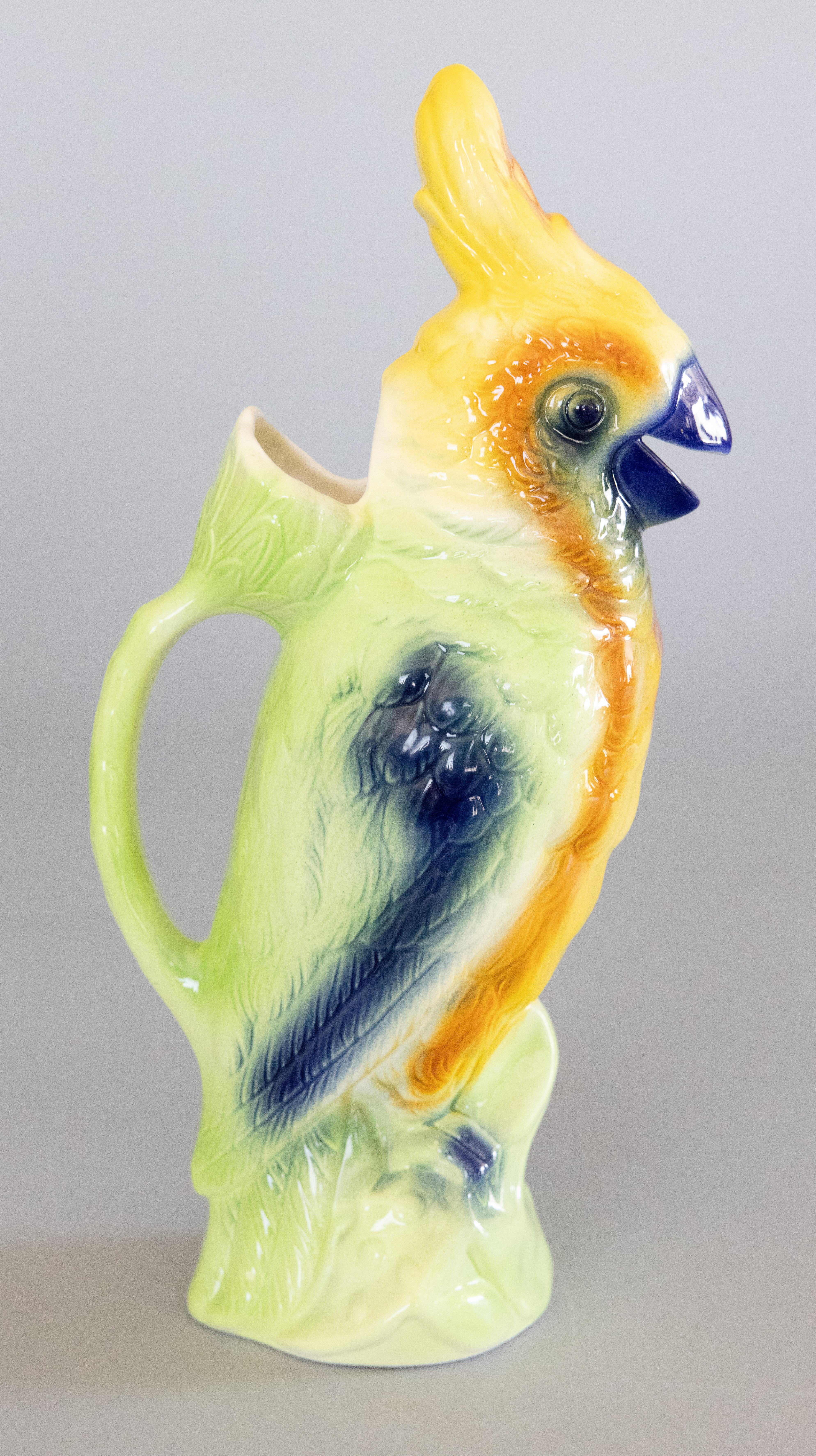 A gorgeous vintage French majolica parrot absinthe pitcher decanter or figural jug hand painted with beautiful vibrant colors, circa 1940-1950. This pitcher was made at the St. Clement faience factory in France and is signed on the