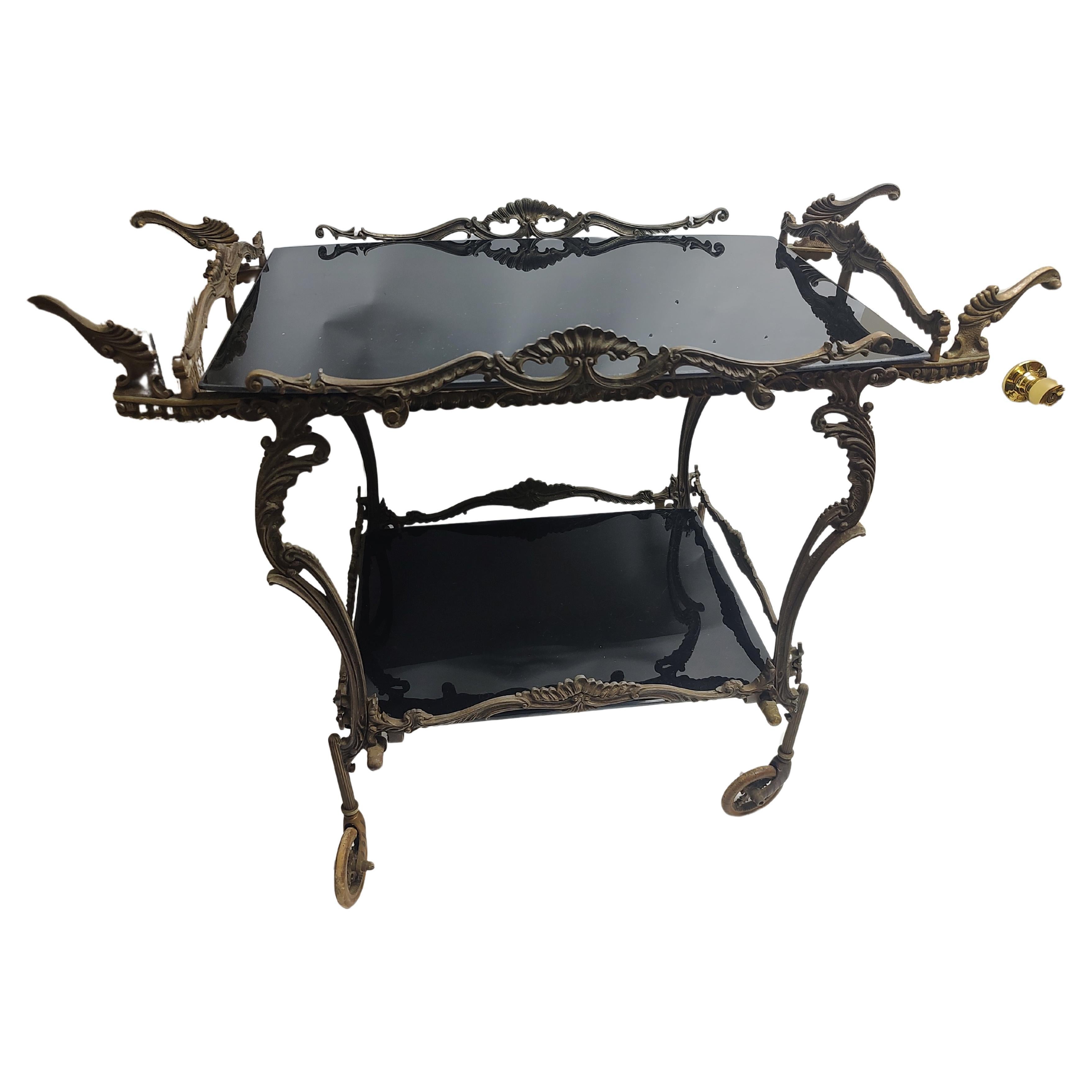 Very elegant with fine brass castings in a petite bar serving cart from France. Two black glass shelves bottom shelf is 19 x 14 and the top shelf is 15.5 x 23. A smaller size for a dining room or patio terrace with a minimal space available. Brass