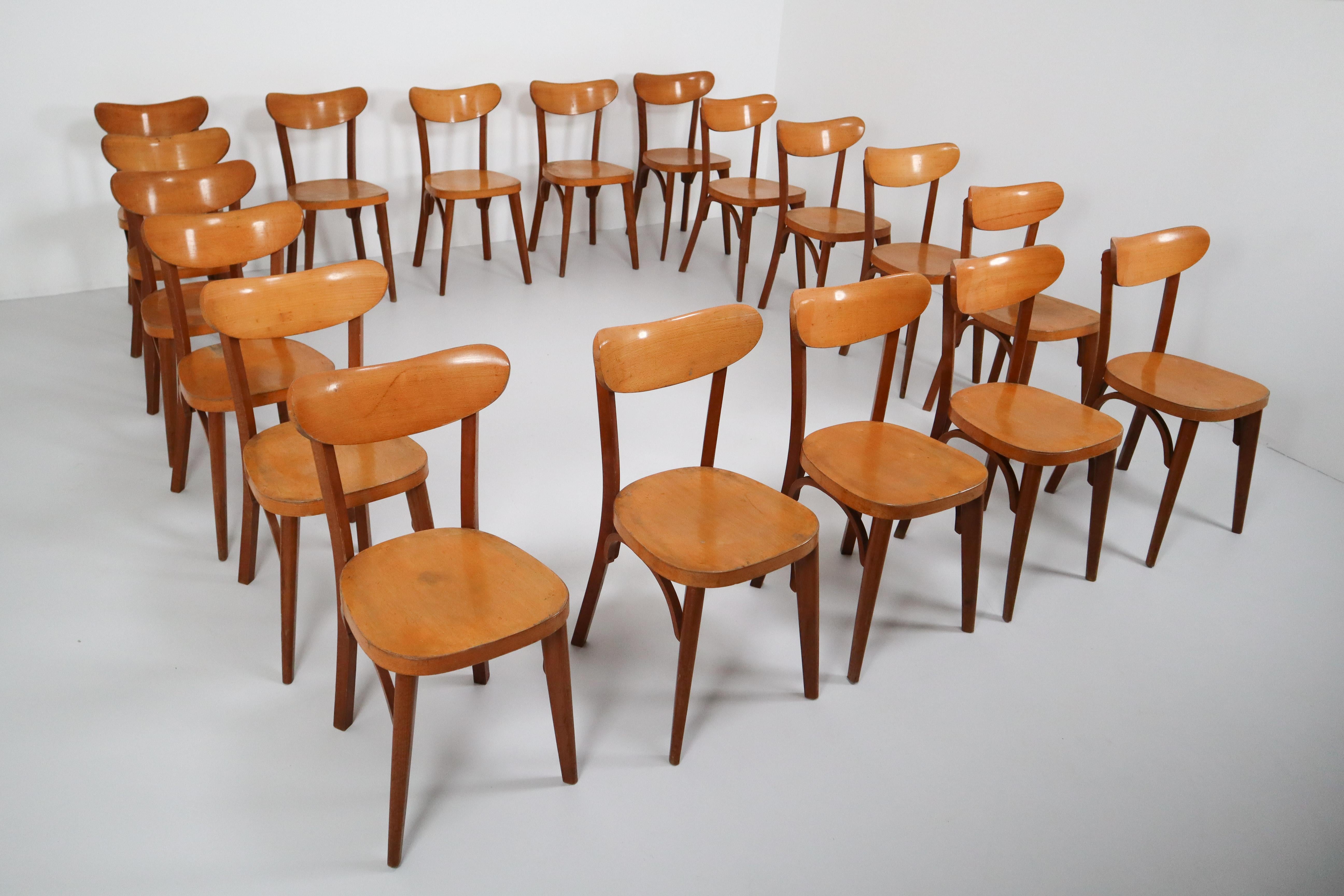 Set of 20 x comfortable Beech chairs, produced in France in the 1950s. These French modern design bistro chairs have a beech bentwood frame and beautifully curved beech plywood seats. Minor wear consistent with age and use. These chairs are in a