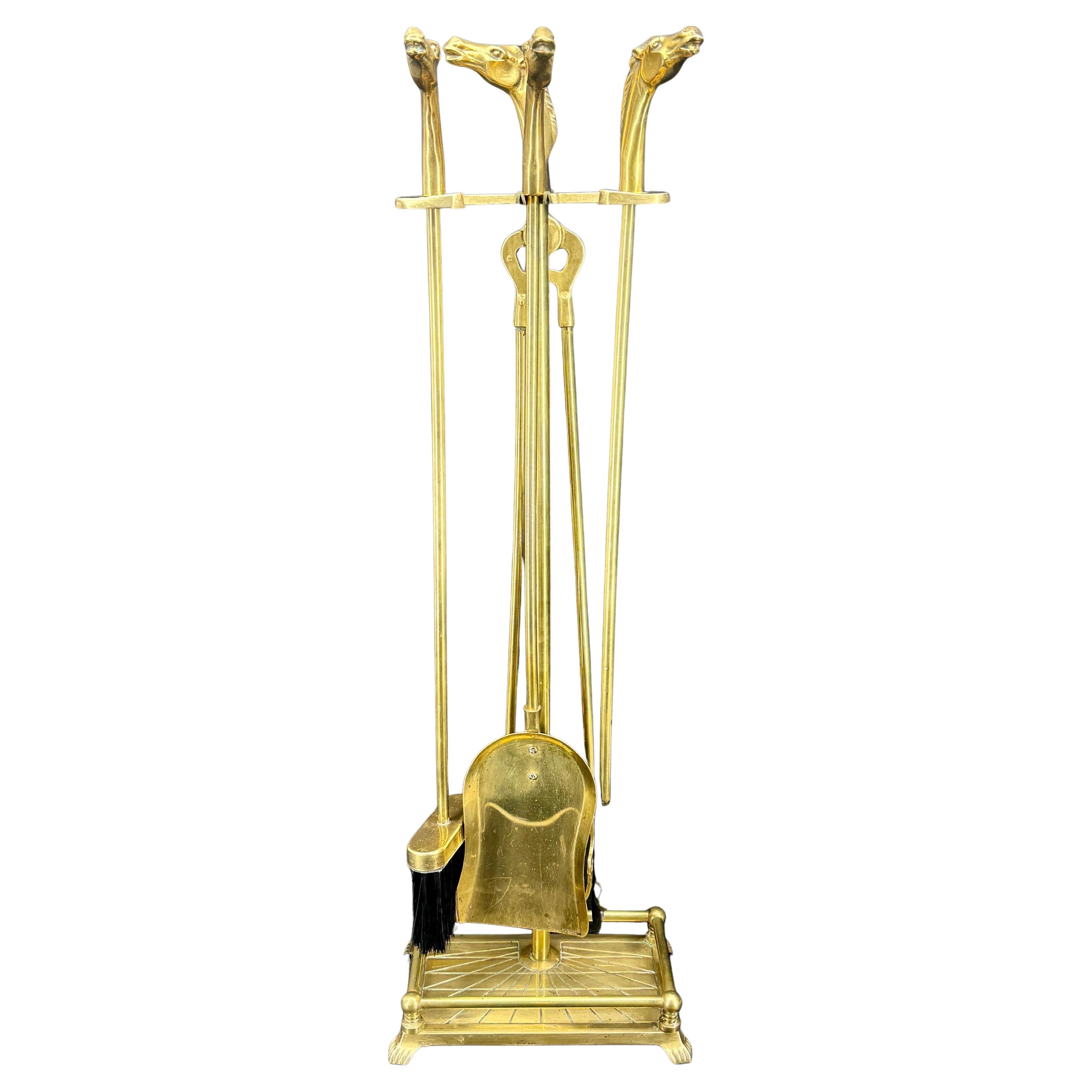 French Set of Brass Horse Head Fireplace Tools, circa 1960's.
This complete set includes a Shovel, Poker, Brush, Tongs and a Tool Caddy Stand. Each is topped with a brass horse bust. The impressive stand has a detailed ornate base that will
