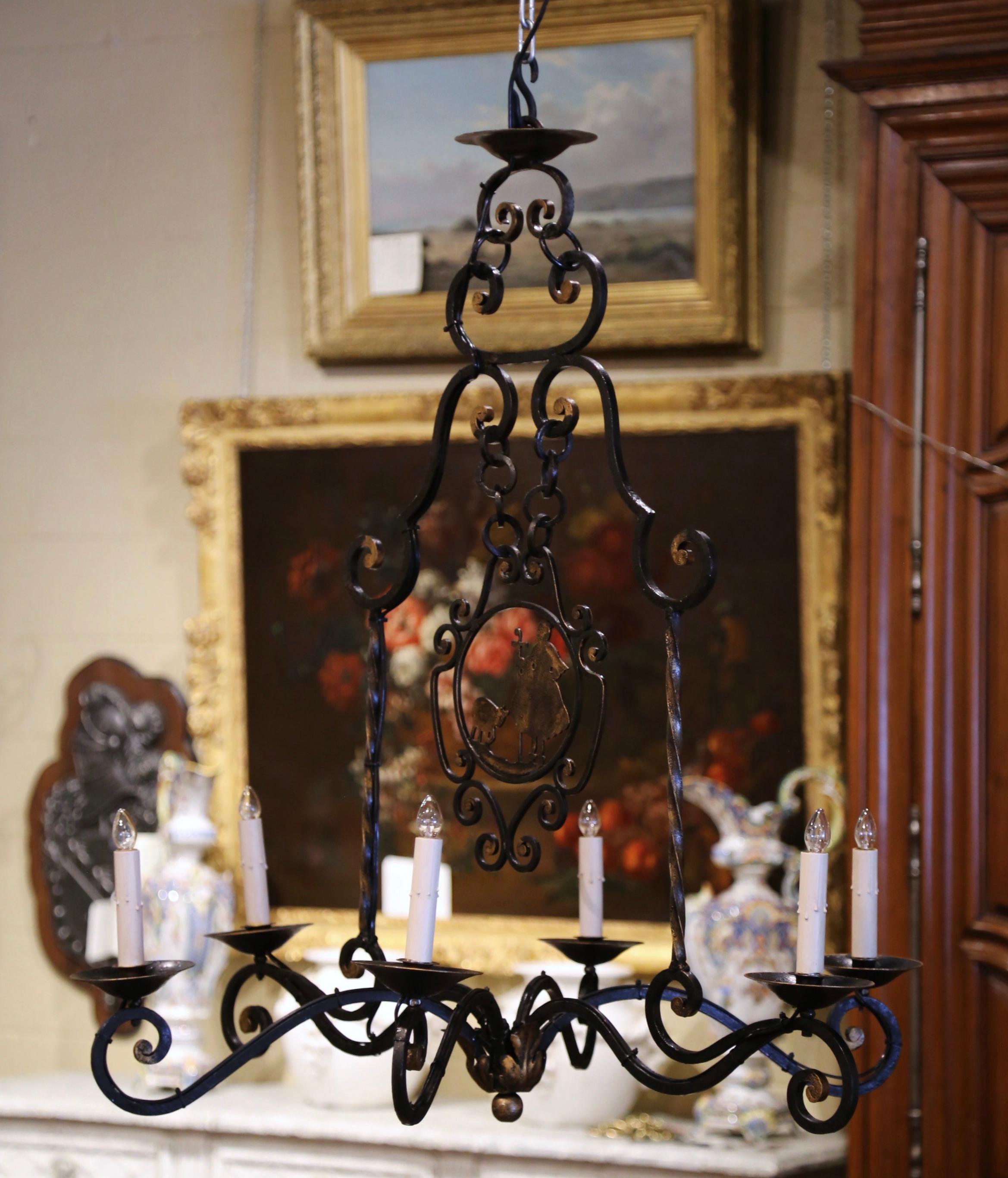Bring some French flair to your breakfast room with this antique light fixture; crafted in France circa 1920, the iron chandelier has six-light embellished with a center carved shepherdess with her sheep. The fixture has been rewired and dressed