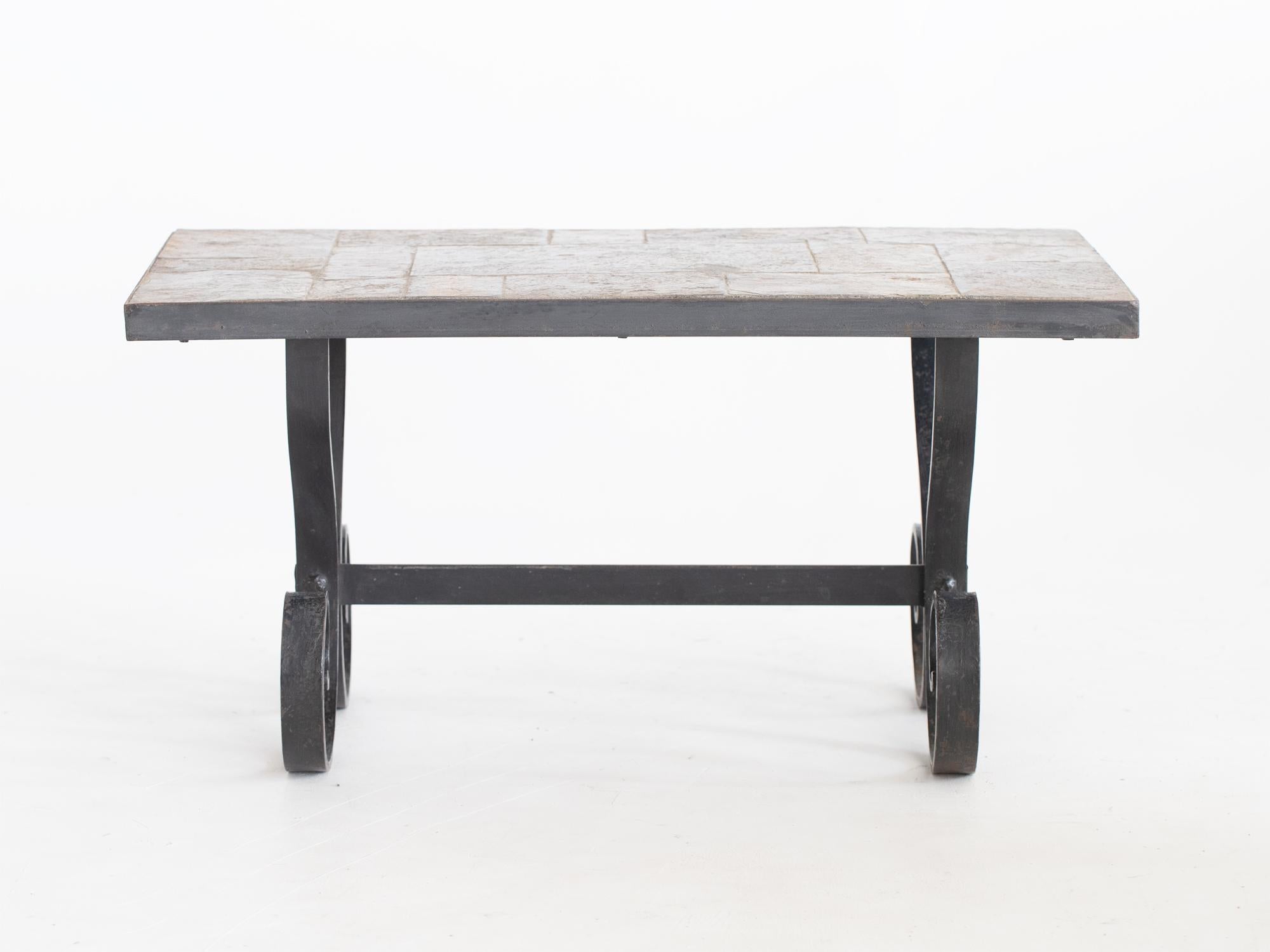 A mid century tiled slate and wrought iron coffee table in the manner of Jacques Adnet. French, mid 20C.

Stock ref. #2202

In good sturdy order. Undamaged slate with worn paint to the base.

40.5 x 80 x 45 cm

15.9 x 31.5 x 17.7 