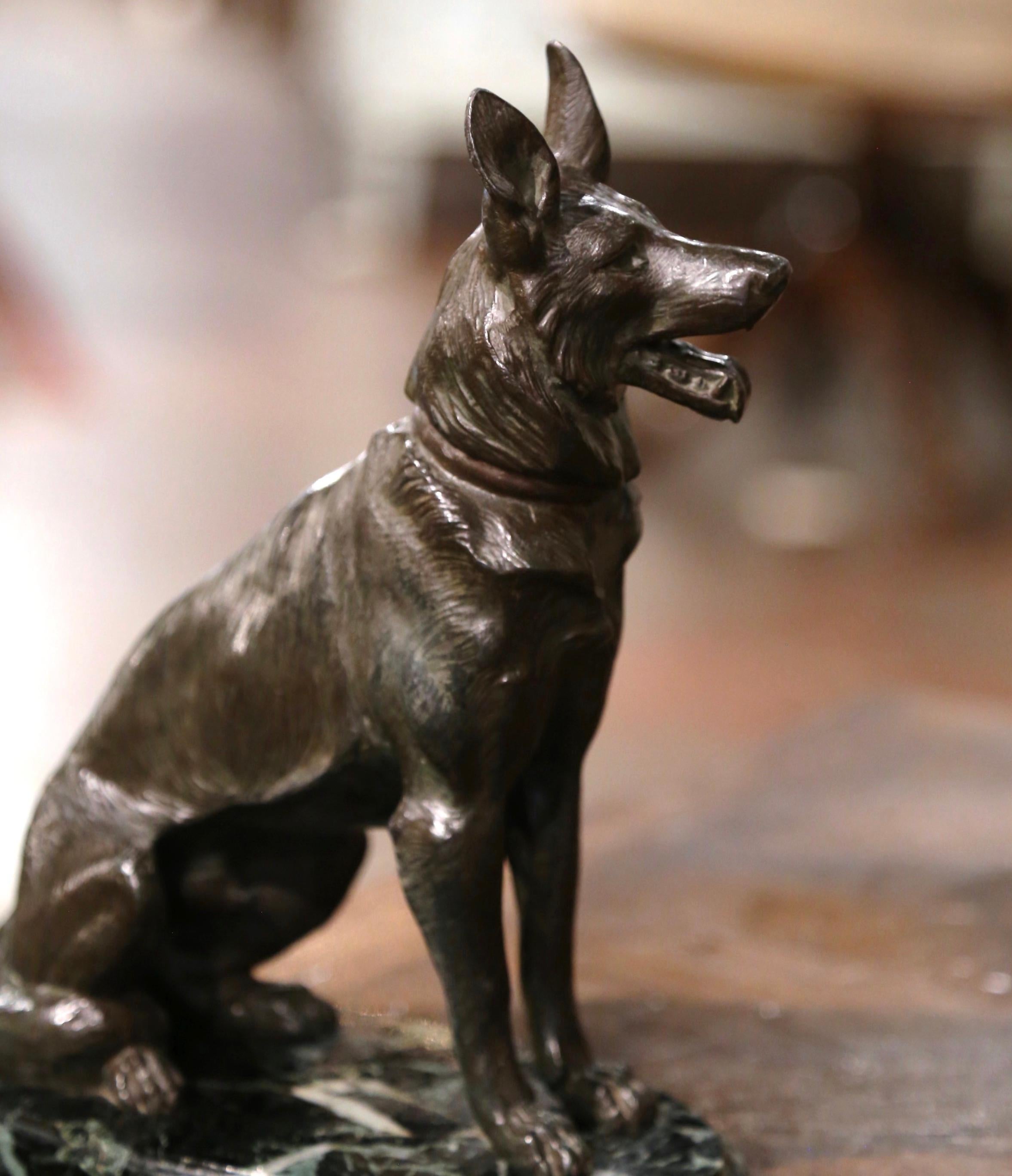 Decorate a man's office or library with this vintage spelter dog sculpture. Created in France circa 1950, and set on a oval green variegated marble base, the figure depicts an German Shepherd sitting at attention and panting. The canine sculpture is