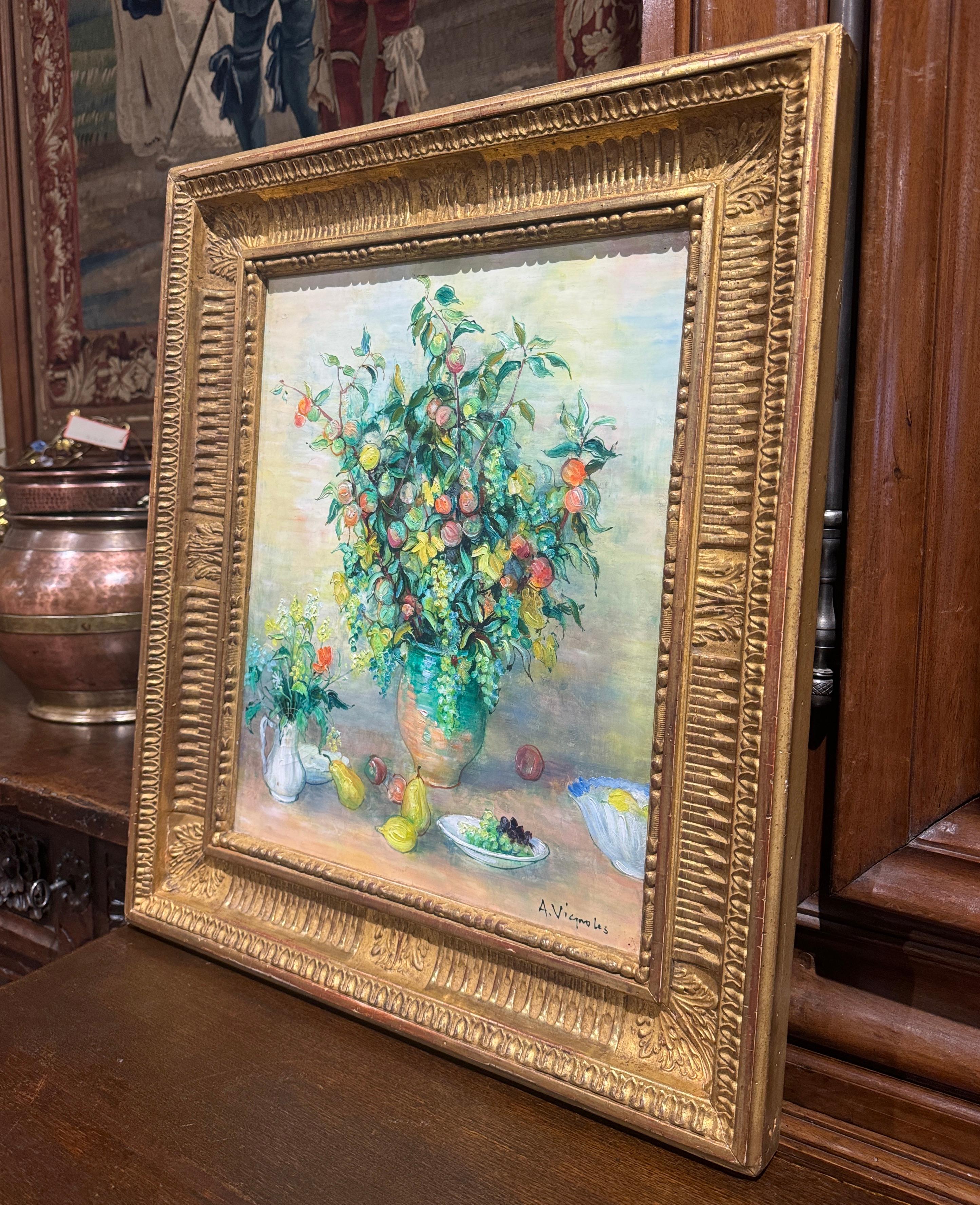 Decorate a wall with this colorful antique painting. Created in France, circa 1960 and signed in the lower right corner by French artist, Andre Vignoles, the oil on canvas is framed in an ornate, gilt frame, enhancing its traditional and elegant