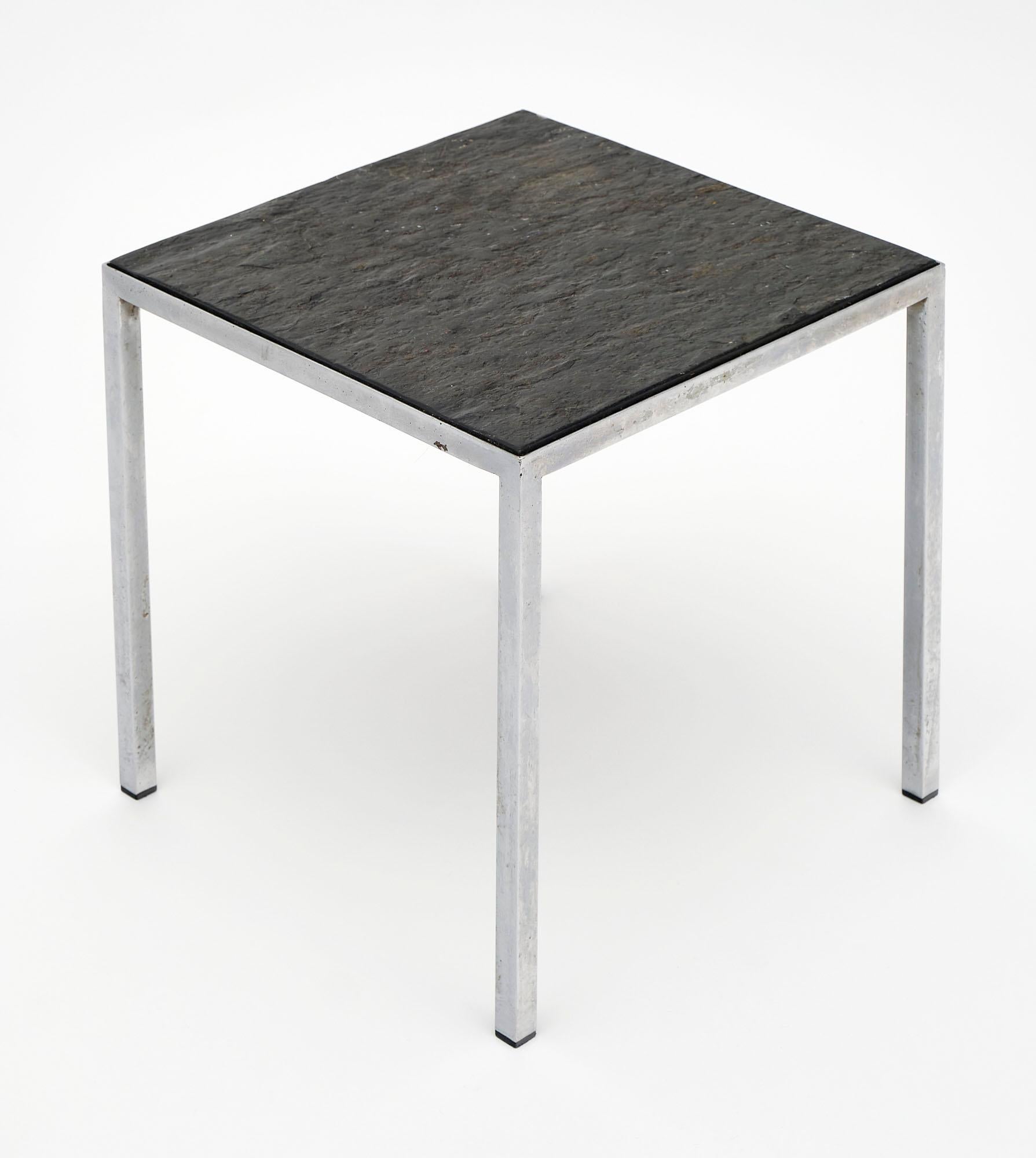 French side table with a chrome metal base and stone top. The superb lines of this piece are clean and striking, especially in juxtaposition of the natural texture of the top.