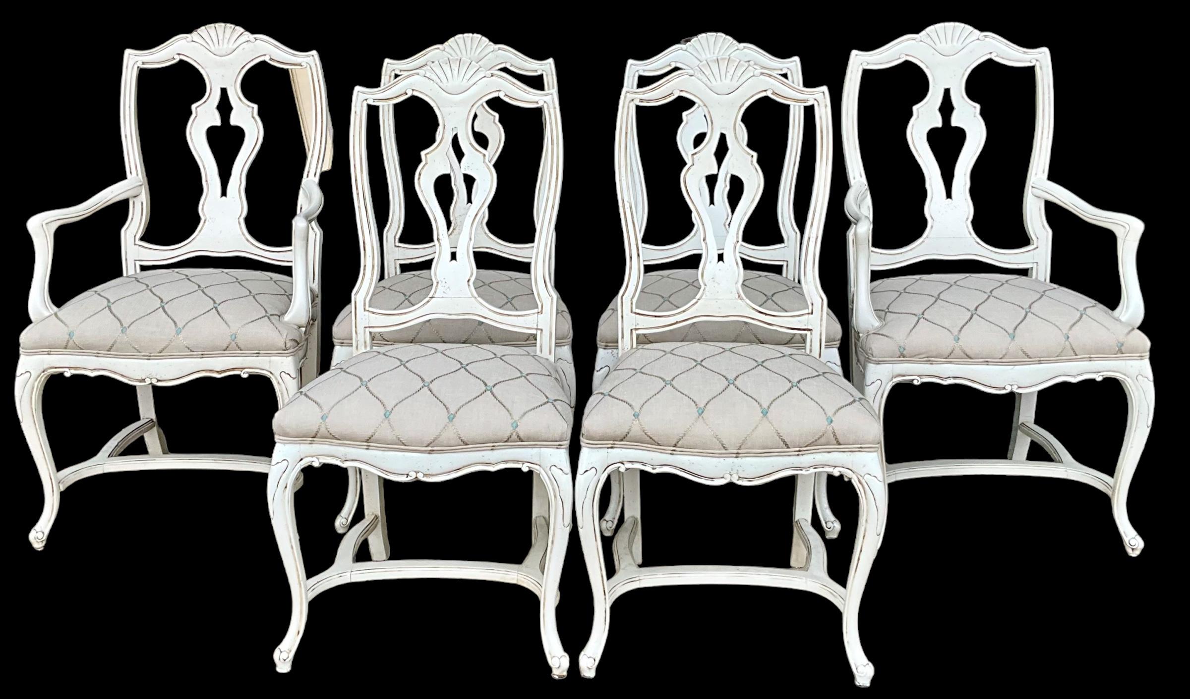 This is a set of French style dining chairs that have been completely re-done. The frames are an antique ivory with a glaze. The upholstery is a new embroidered linen. They are in very good condition and unmarked. Side;20.75”L x 19” W x 41.5”H. Seat