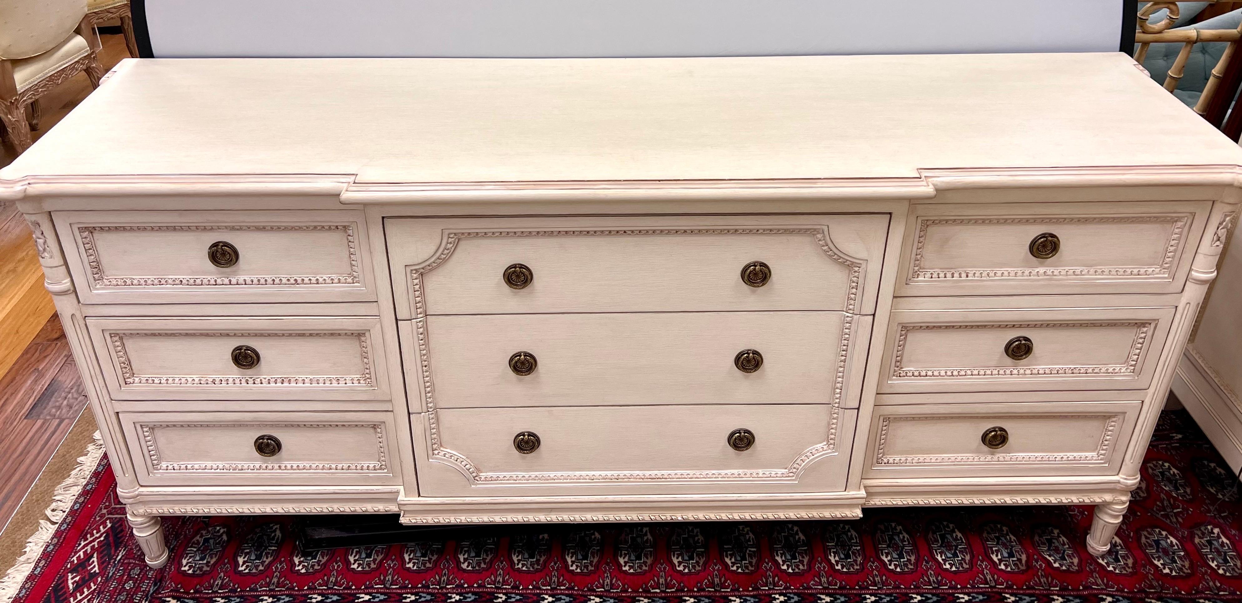 French style dresser by Louis J. Solomon is meticulously crafted with intricate carved details and a beautiful distressed cream finish. Part of a larger set and note we are selling each piece individually. With nine drawers, it offer functionality