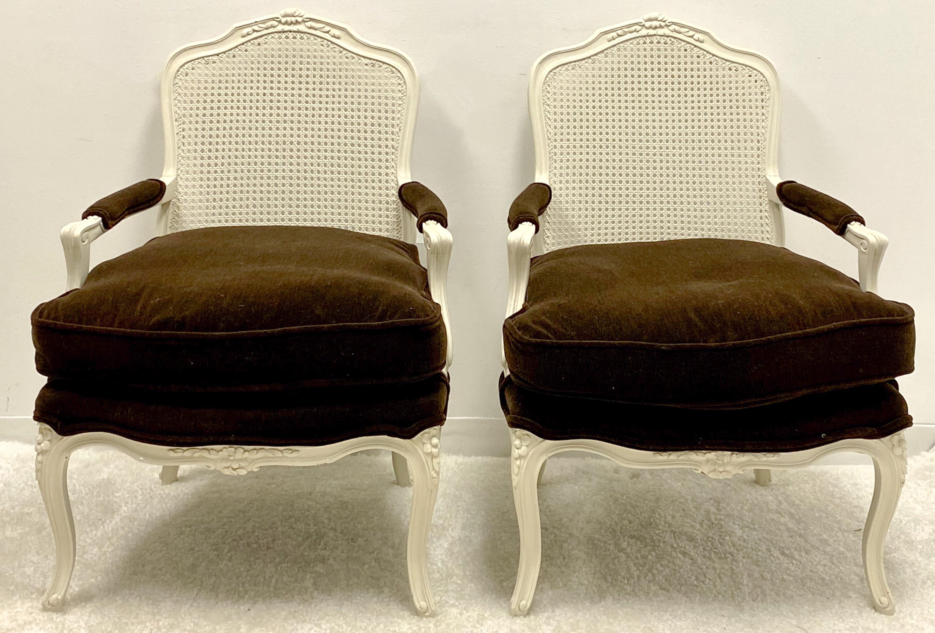 This is a mid-century French style pair of painted bergere chairs in brown mohair upholstery. The cushions are a thick down. The frames are painted white. They are in very good condition.
