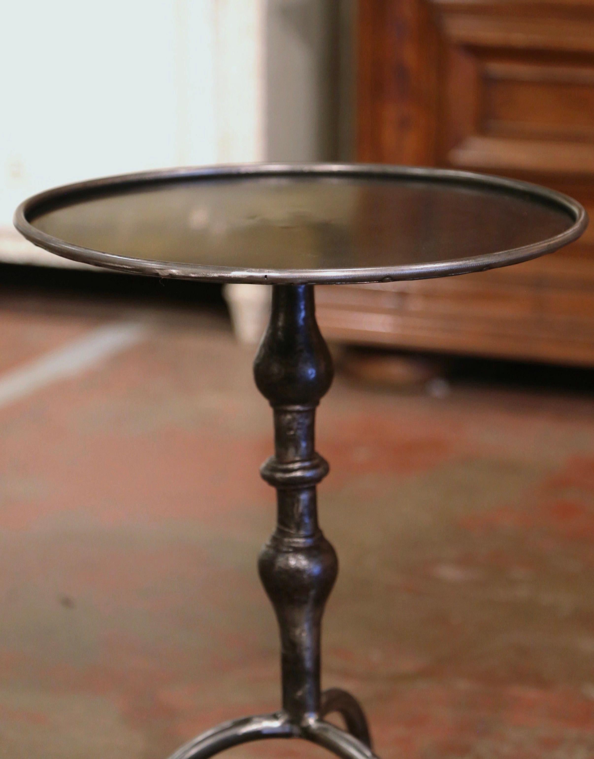 This elegant, antique pedestal table was crafted in Southern France, circa 1960. The martini table features a central turned pedestal stem over three curved legs ending with small feet. The serving table is topped with a round surface from later