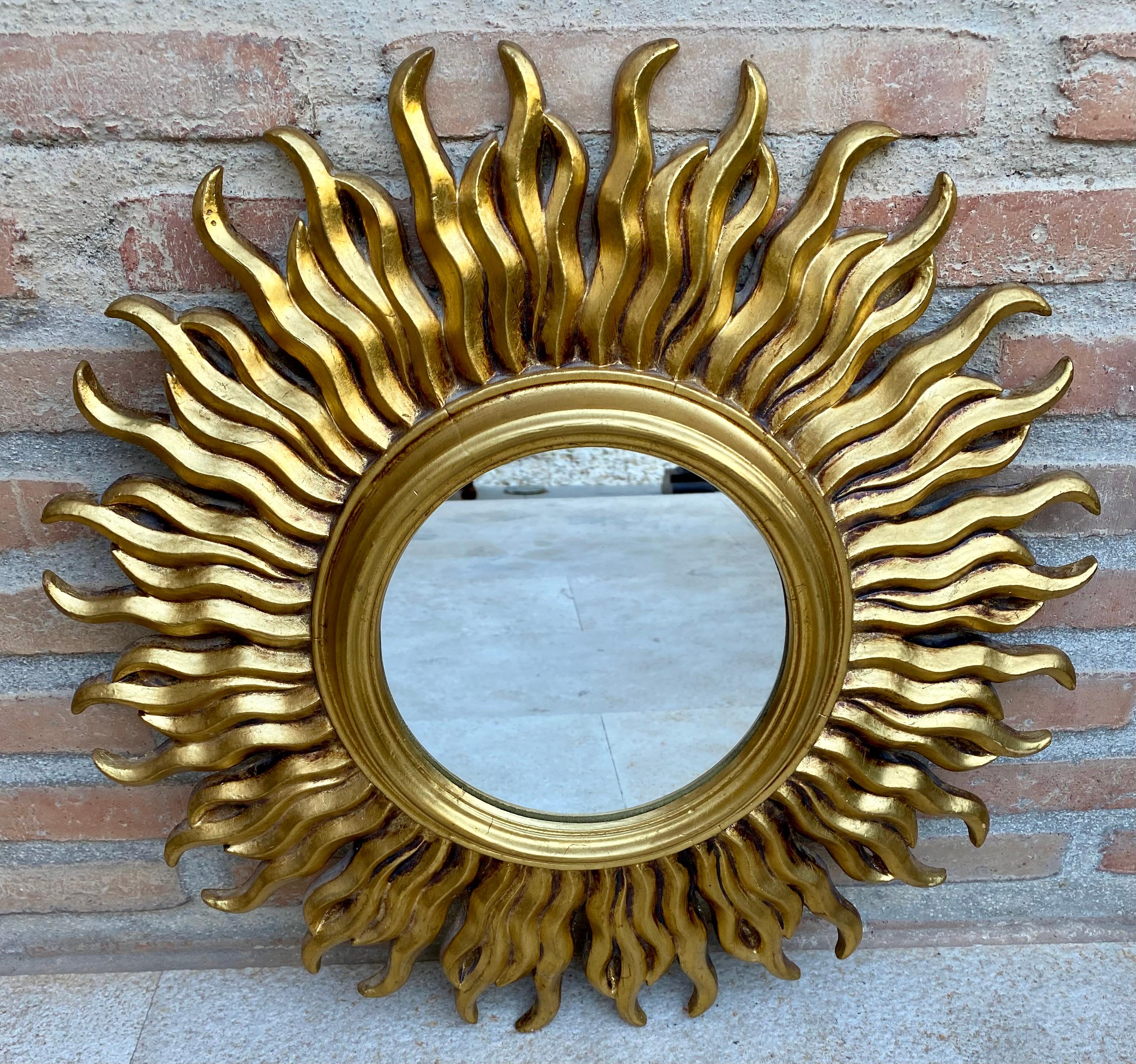 Mid 20Th French Century Sunburst Mirror in Gold.
Midcentury Tiered and Gilt Sunburst Mirror from France.