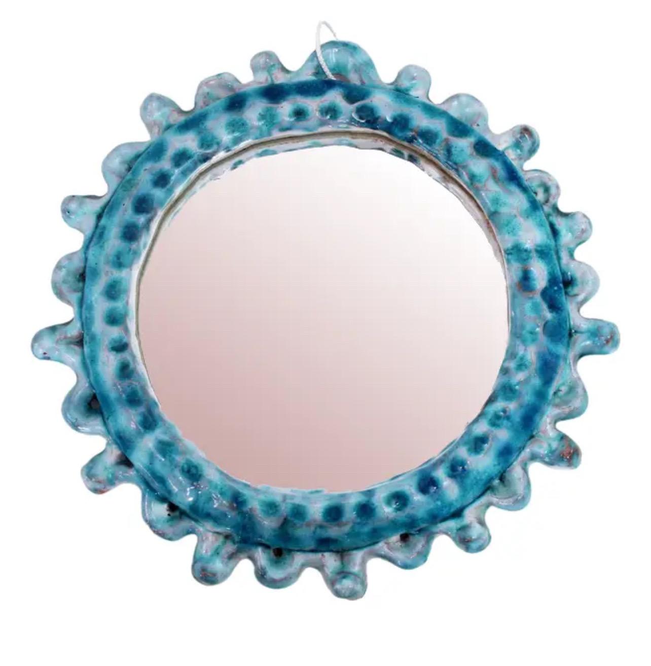 Mid-century French turquoise ceramic sunburst mirror. Textured turquoise ceramic frame with inset mirrored glass. No makers mark or signature. Mirror is heavy and well made.
Hanging hardware is not included. 