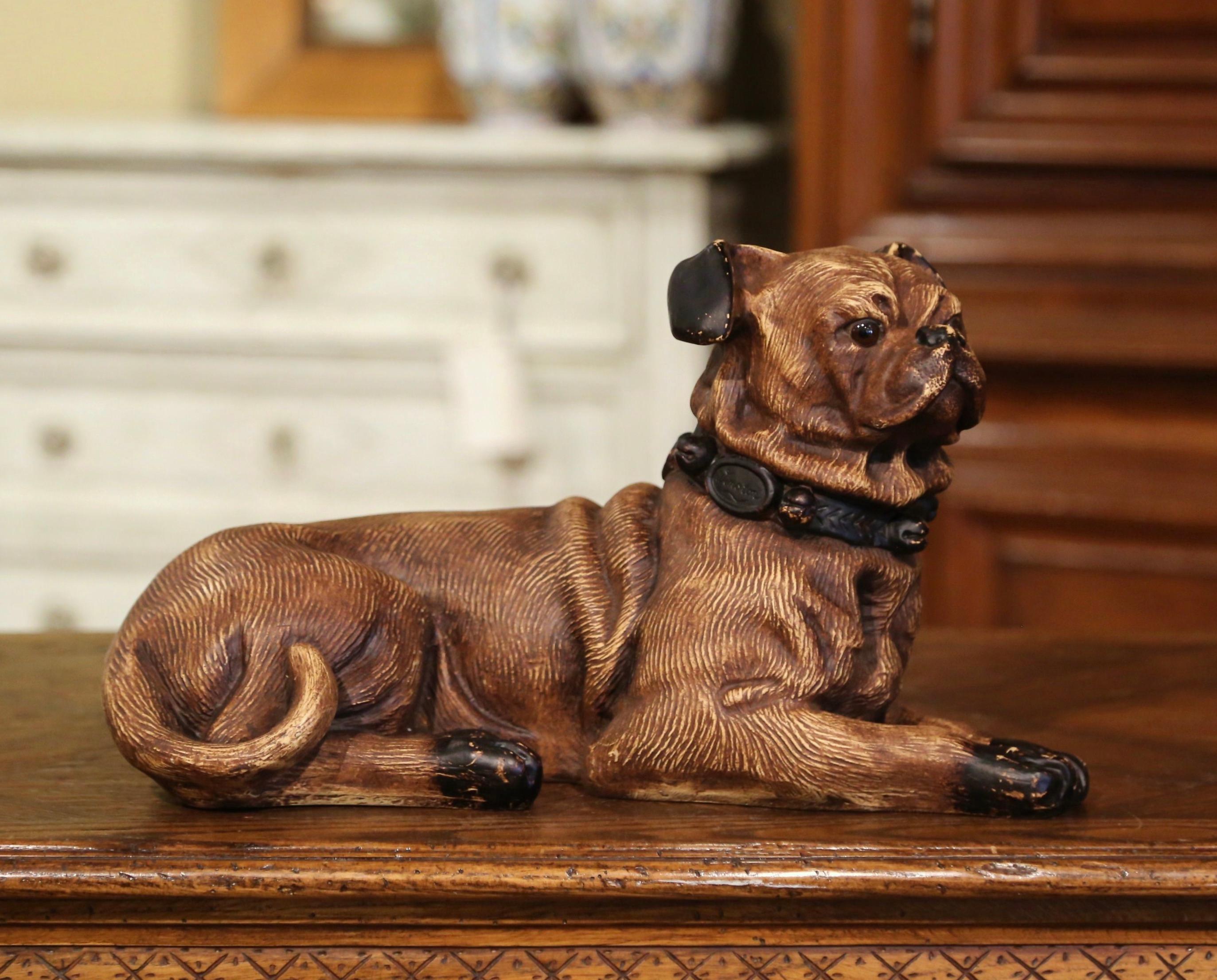 Dog lovers will appreciate this realistic vintage pug. Crafted in France, circa 1950, the antique dog sculpture features a resting puppy pug; the canine with wonderful facial expressions, has detailed features including on the neck and hair, and has
