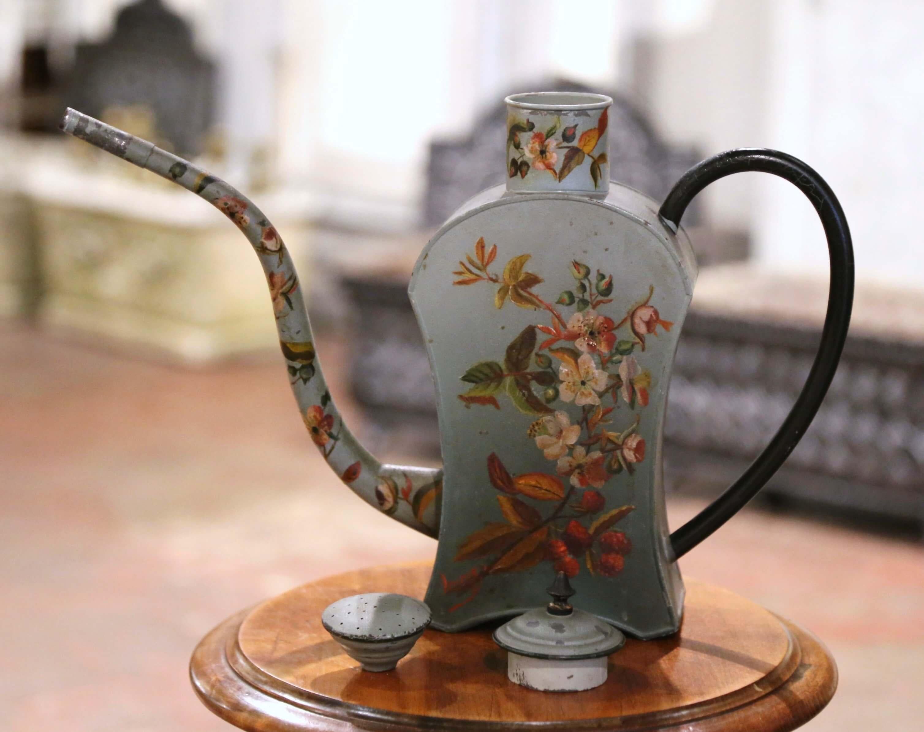 Decorate kitchen cabinets with this antique water can with its original removable lid! Hand crafted in France circa 1960, and built of metal, the tole construction gives this watering can a charming and unique character. Adorned with hand-painted