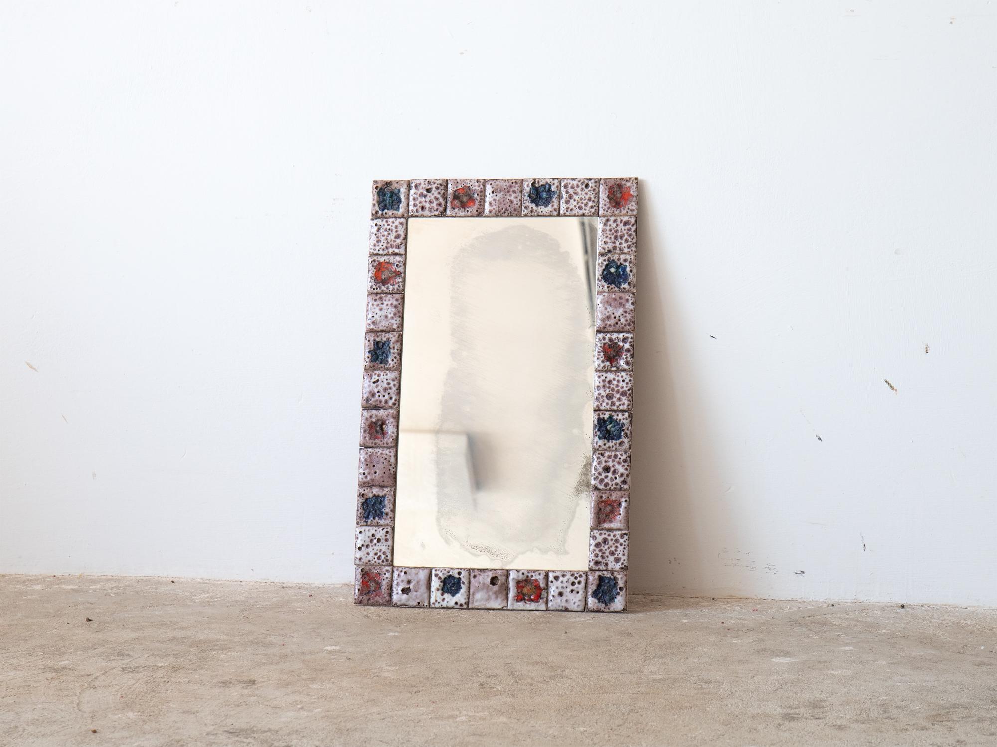 A mid century wall mirror with Vallauris ceramic tile frame. Southern France, c. 1970.

In very good order with no damage to the tiles. Original distressed plate.

55 x 35 cm

21.7 x 13.8 “