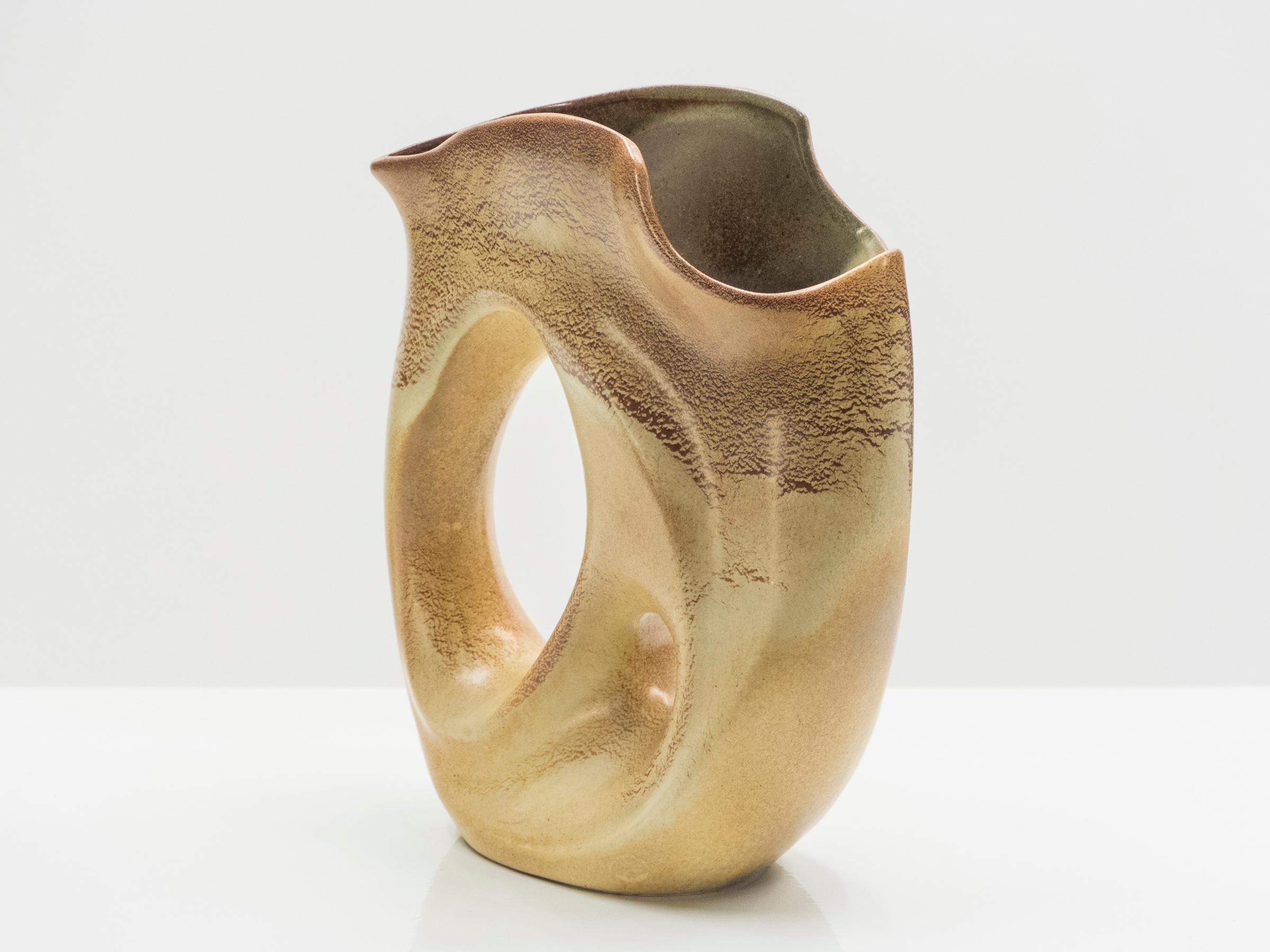 This curved French Vallauris vase would be beautiful in any space. It was created in the 1960s by a French ceramicist from Vallauris. With a feminine body and a rich beige combination of colors, this vase is really one of a kind, chic and timeless.