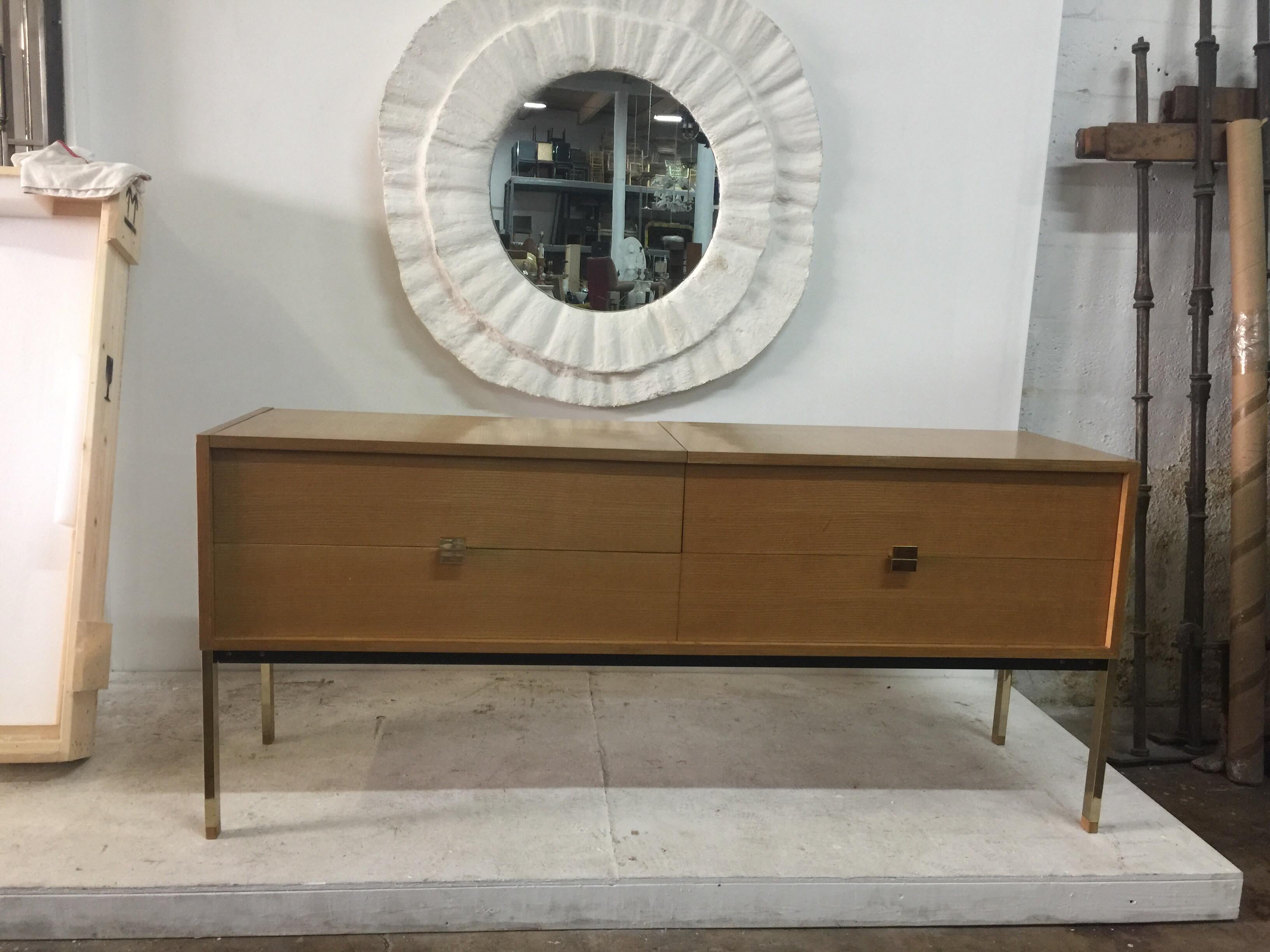 This is design by Roger Landault in the 1960's; It is truly unique cabinet that opens on the left side to an area that can be used as a vanity or bar area, depending on where you place it. Mirror is embedded within. The right side are ample drawers