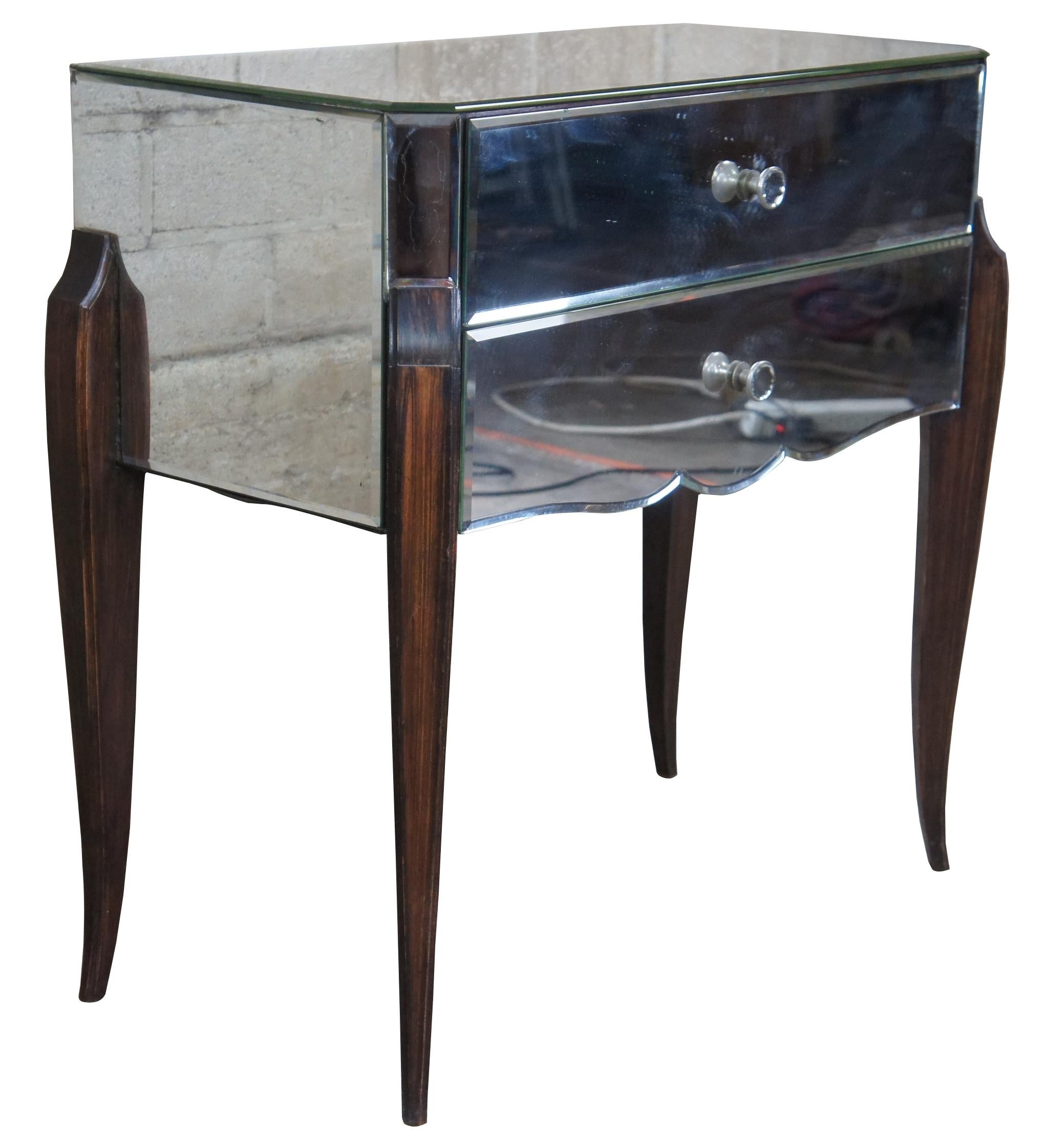 Circa 1960s French mirrored entry chest or side table. Made from Macassar ebony with beautifully cut and beveled glass panels. Features 2 drawers with old world dovetailing.
  