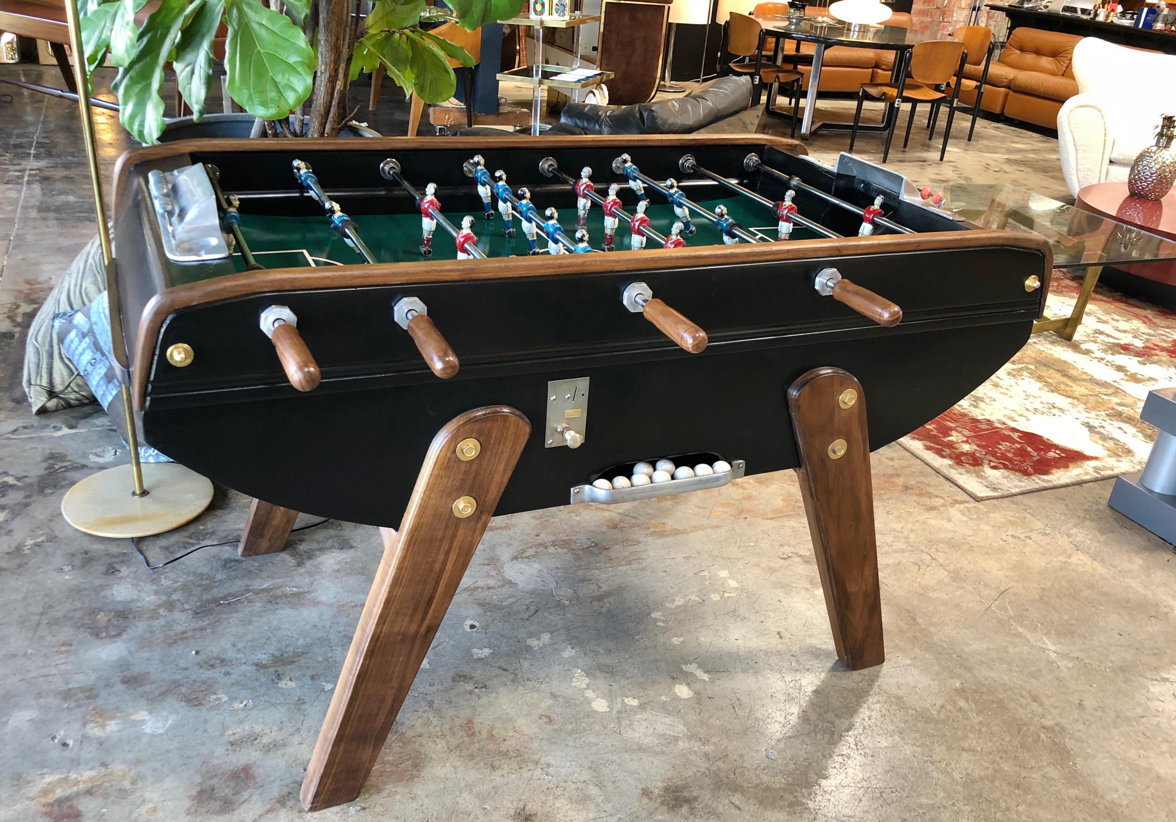 Midcentury French black and brown wood foosball table in walnut.
Our modern spin on an old game.