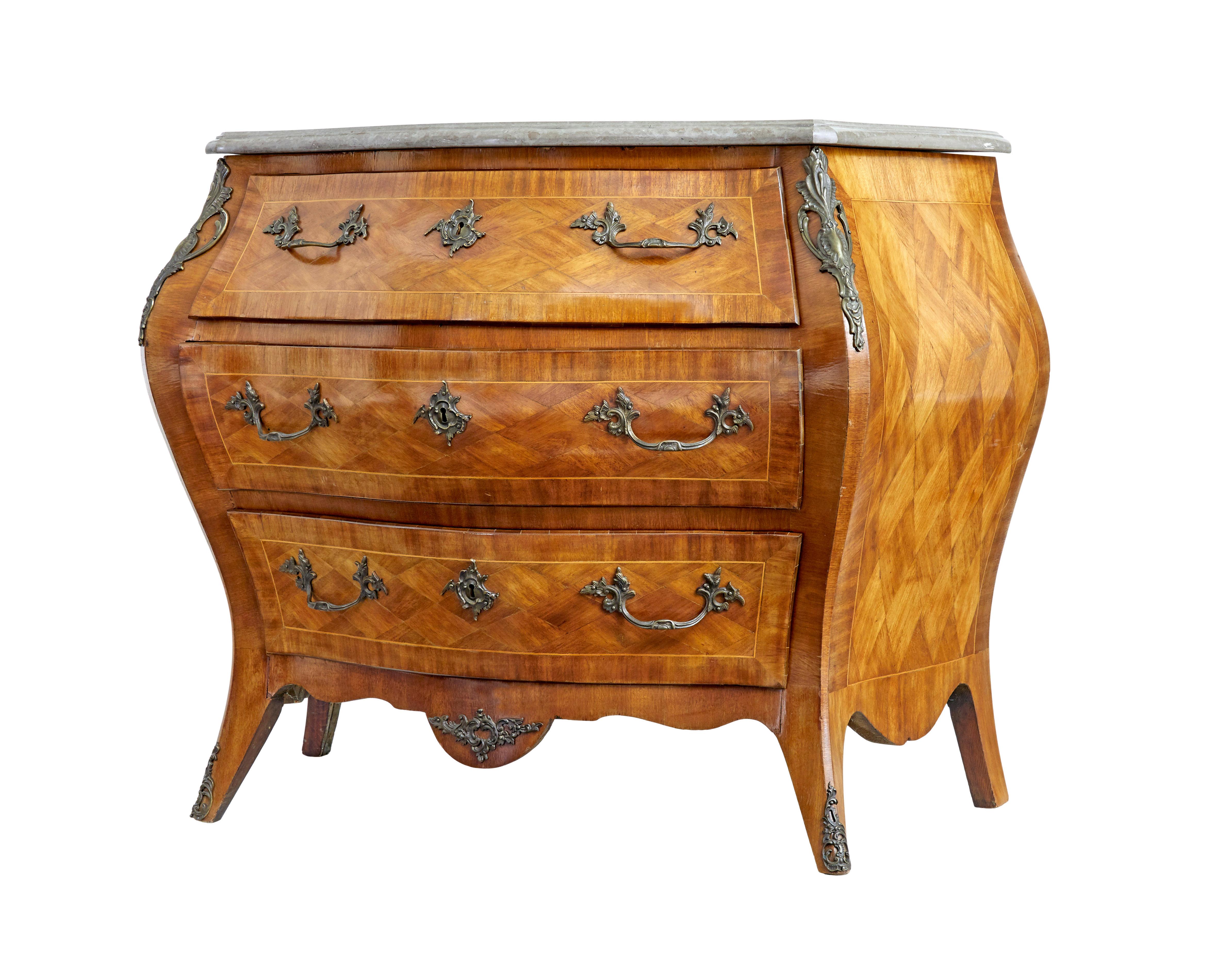 Mid century French walnut marble-top commode circa 1950.

Good quality french bombe shaped commode in the rococo taste.  3 drawers fitted with ornate handles and key plates. Parquet arranged drawer fronts and sides and stringing. Grey marble top