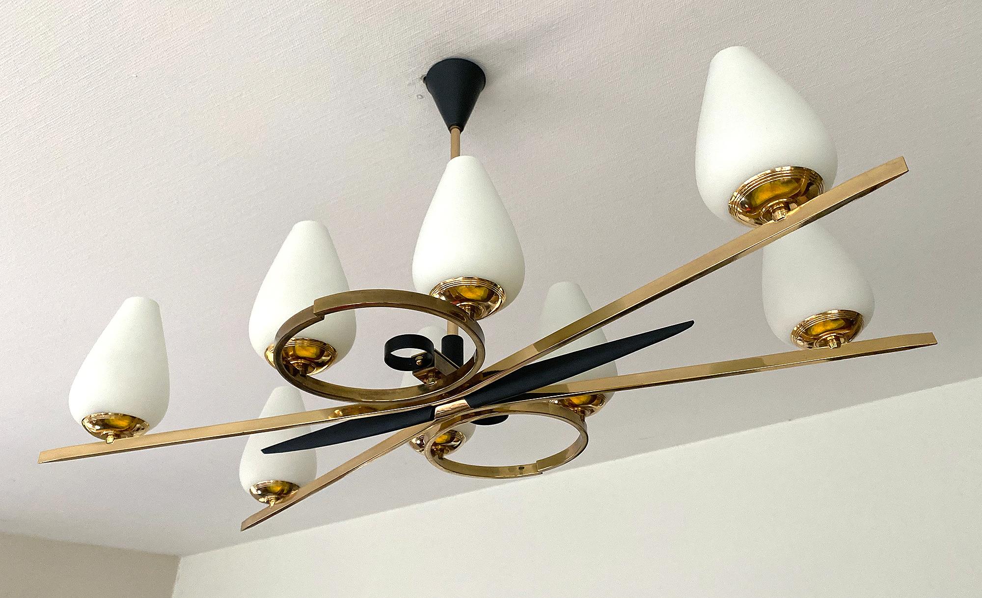 Exceptionnal large chandelier by Maison Arlus, this is the ONLY ONE available worldwide! 
it features an X-shaped brass structure flanked by 2 double circles with black enameled trim and centre piece, egg shaped opaline glass globe shades.  
Wiring:
