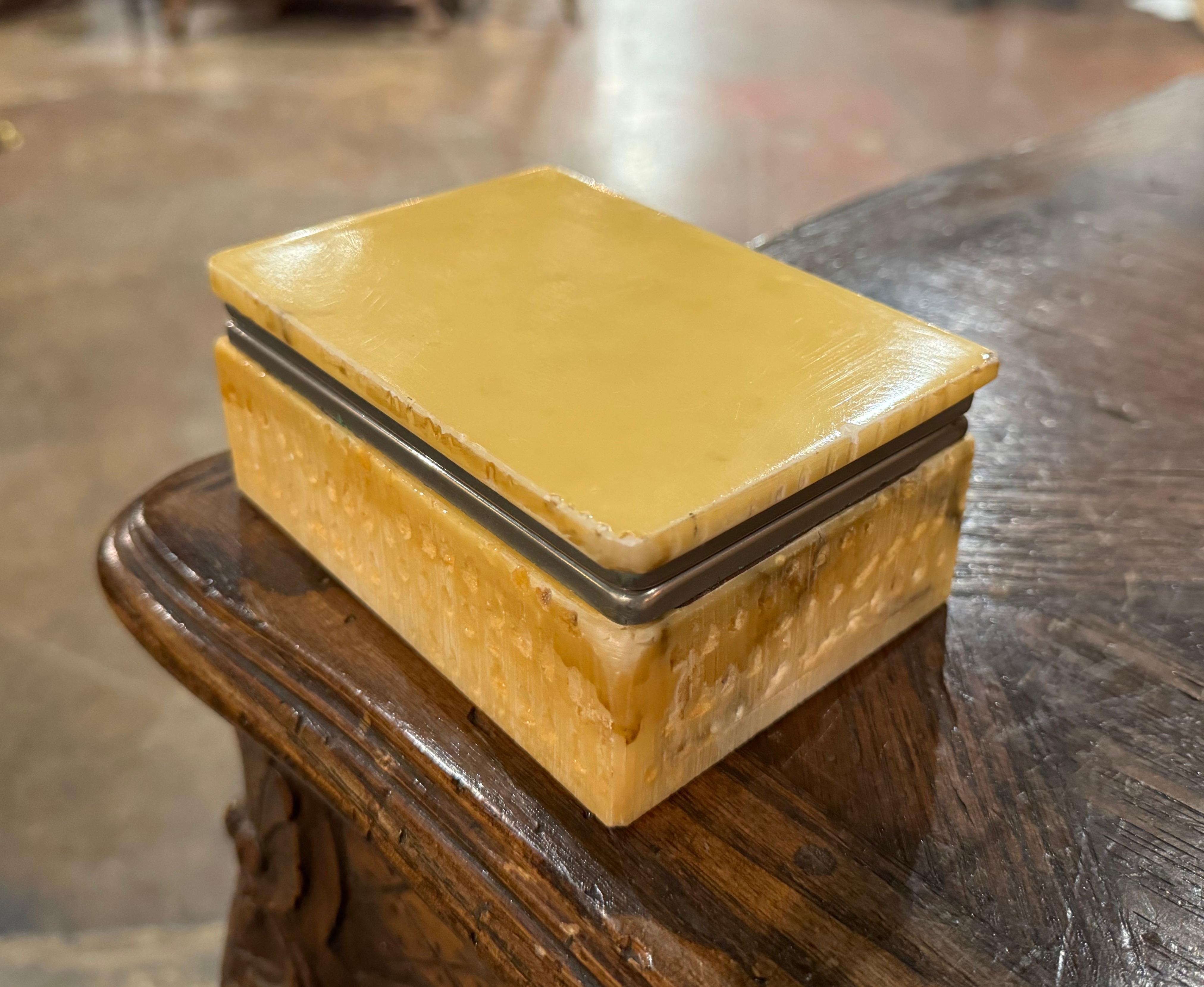 Keep your jewelry safe in this elegant antique marble box. Created in France circa 1950, the casket sits on small square feet. The top open and reveals inside storage. The decorative marble box is in excellent condition commensurate with age and use