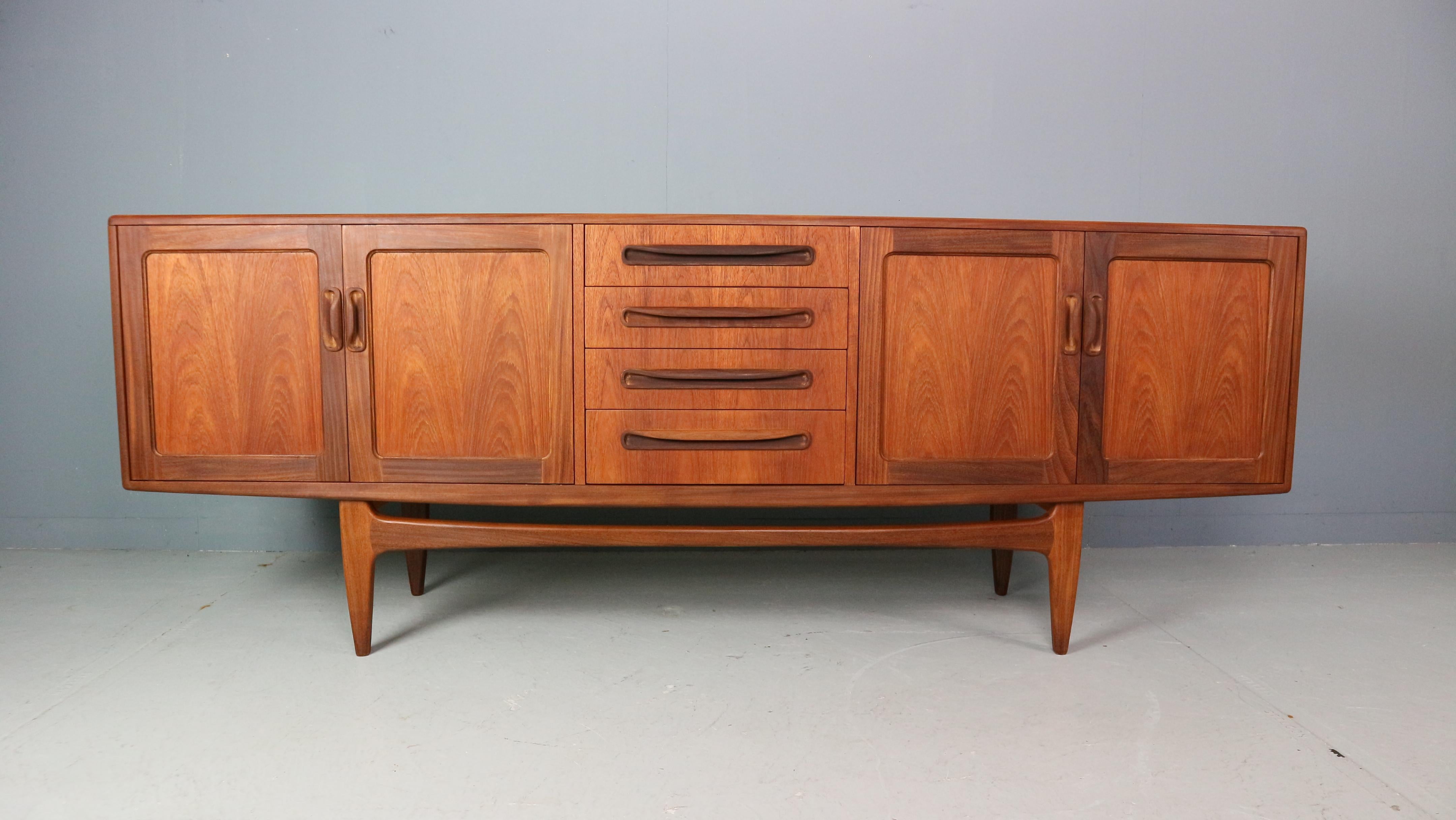 This vintage sideboard is one of the classic mid century sideboards. It was designed by Victor Wilkins for G-Plan in the 1960s and has great retro style. Two double cupboards either side of a central bank of drawers offer ample storage space. Those