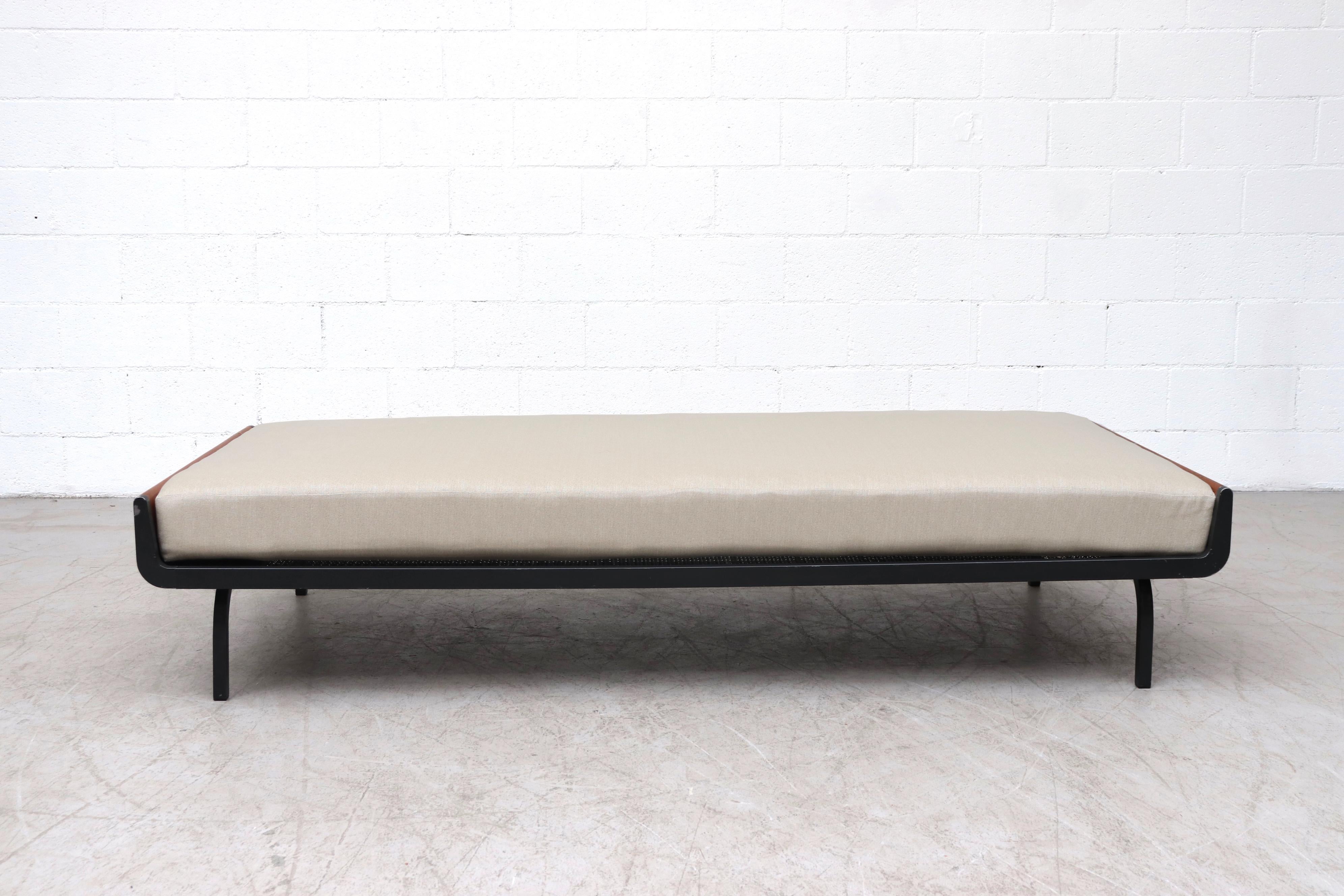 Mid-century daybed with lightly refinished teak ends and grey enameled square metal legs for Auping. Freshly upholstered bone white mattress on wire mesh support with original manufacturer stamp. In original condition with some enamel loss and wear