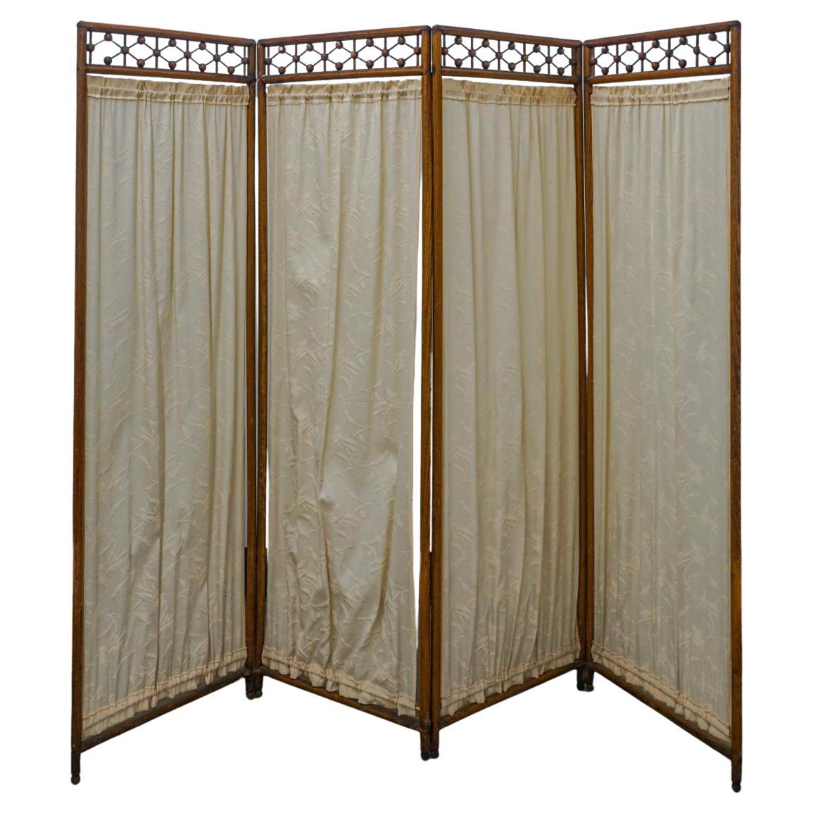 A Mid-Century Fruitwood and Textile Four-Fold Wooden Galleried Floor Screen. Measures 80