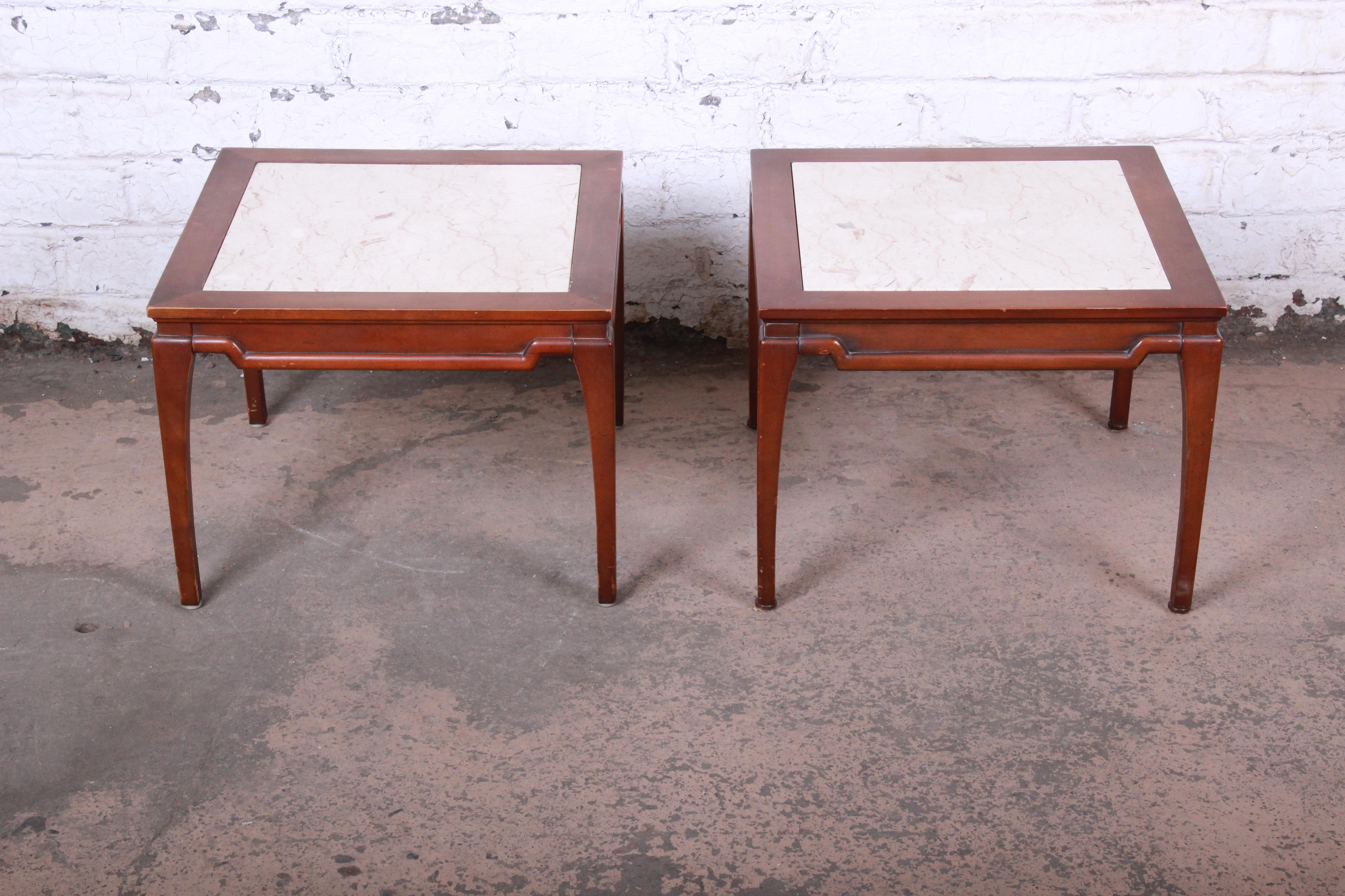 A gorgeous pair of midcentury marble-top side tables. The tables feature beautiful fruitwood frames with inset Italian marble tops. Each table is stamped 