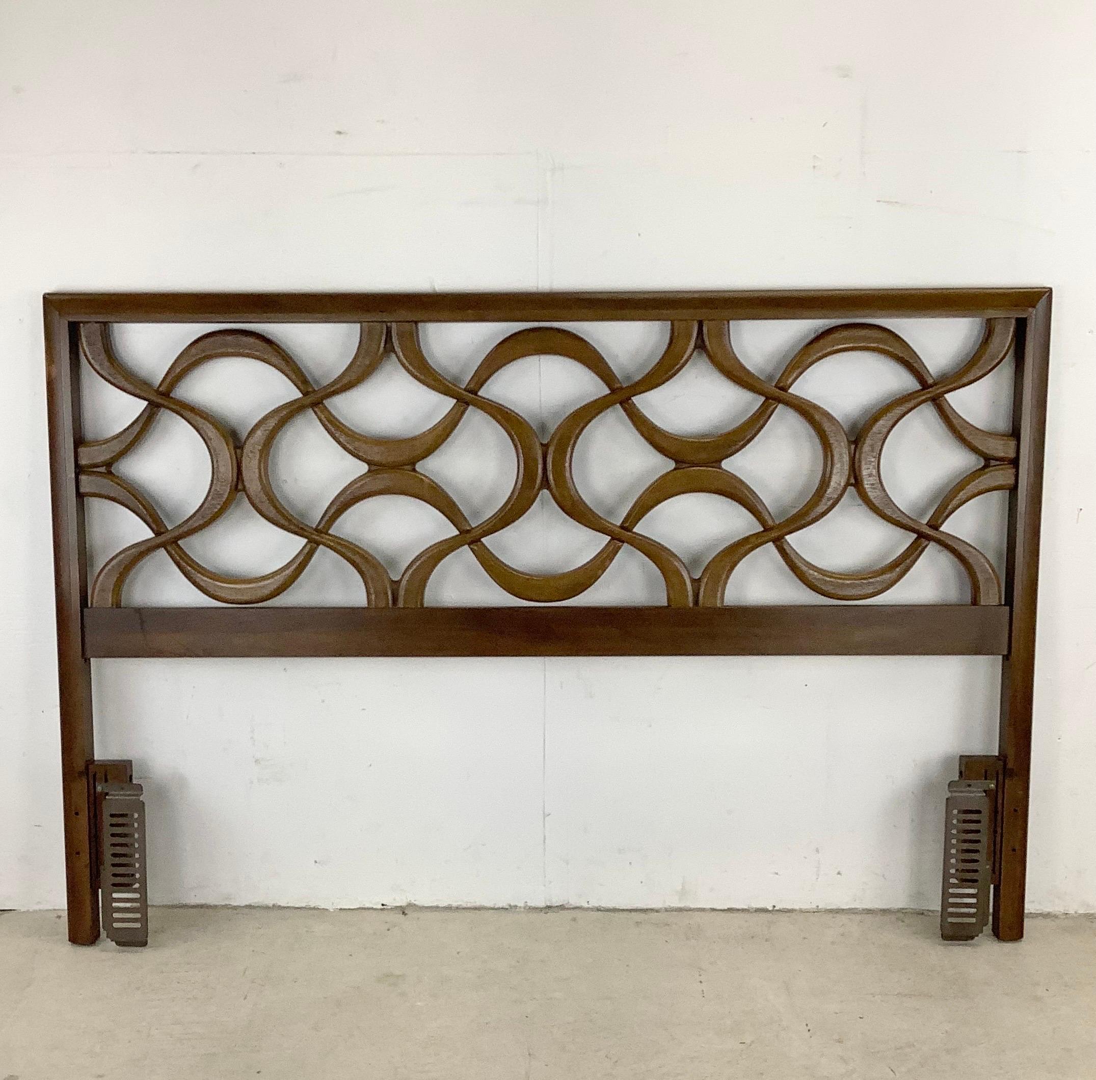 This striking vintage modern headboard features a dark walnut tone and applied front sculptural detail. The uniquely decorative vintage style of this mid-century headboard make it a subtle yet stylish centerpiece to any bedroom and at sixty inches