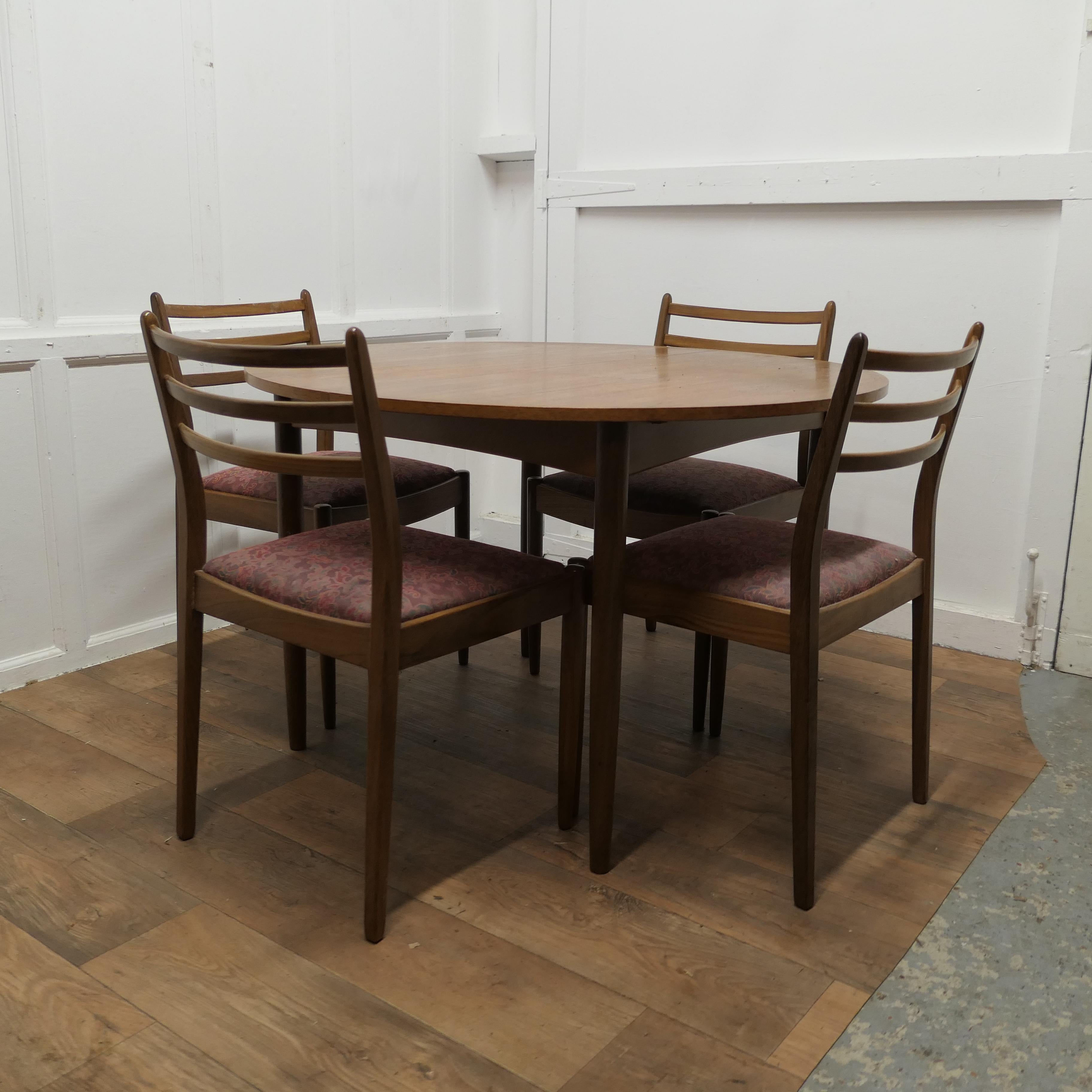Mid Century G Plan Circular Extending Dining Table and 4 Chairs

The Table is in Teak from the Fresco Danish Range produced in the 1960s and 1970s
The table is circular when closed and extends using the centre pop up leaf, when fully extended the