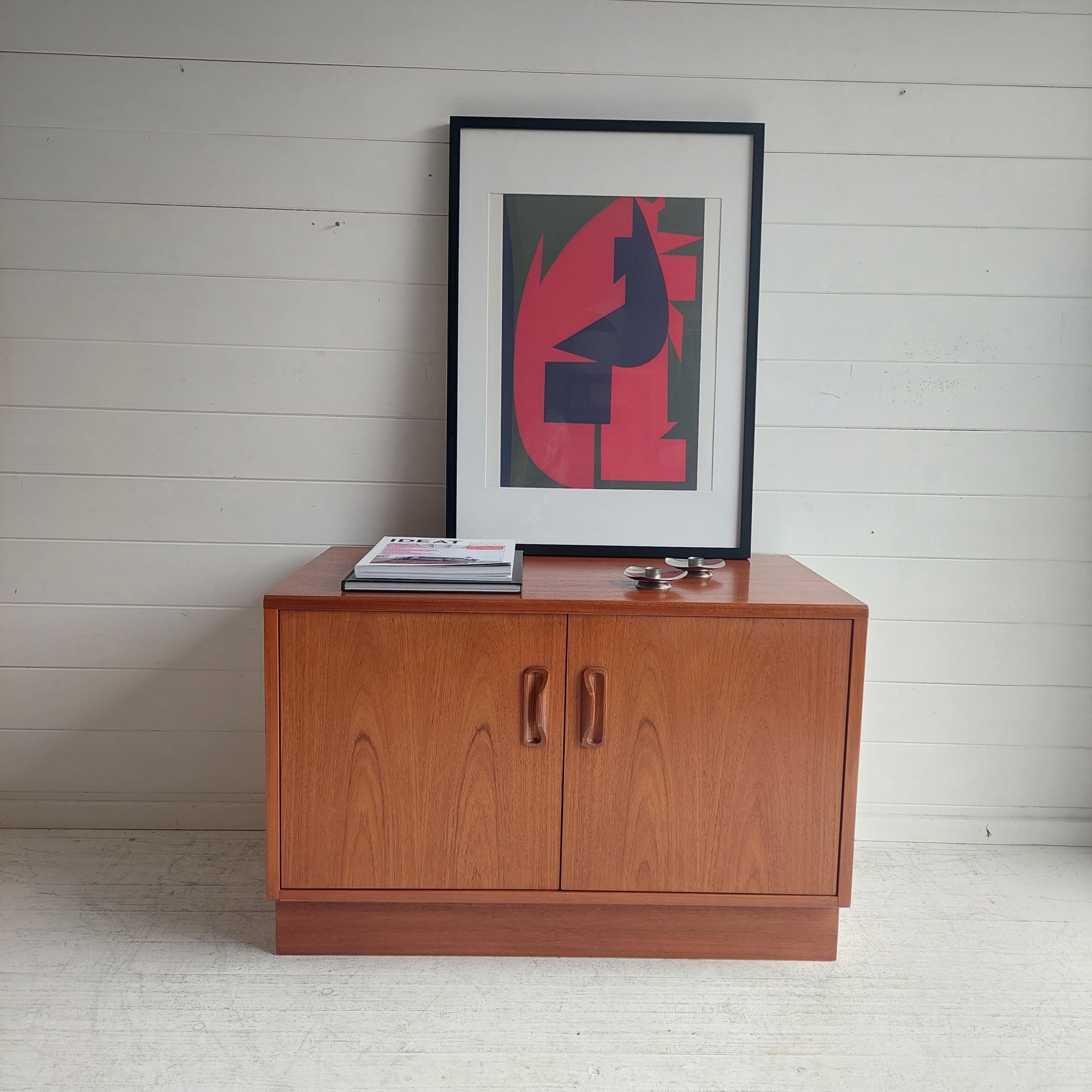 70's G plan Teak two door cabinet designed by Victor Bramwell Wilkins for Gplan.

It is made in 1970s by G Plan out of exotic timers mostly Burmese Teak(a mellow medium light teak colour) .
The cuts were carefully chosen to accentuate the wood